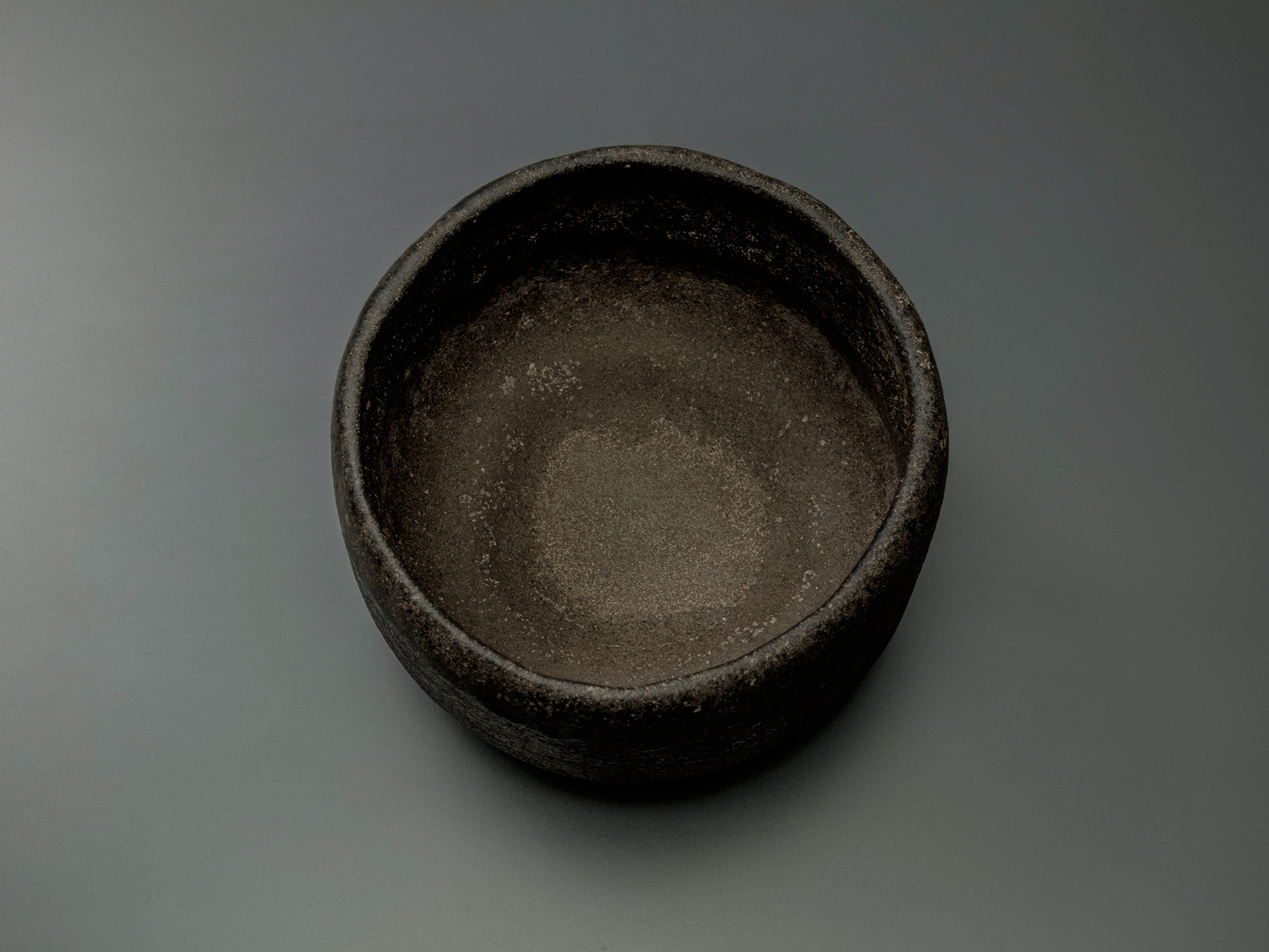 Interior (mikomi) of Chōjirō’s Raku tea bowl Musashino, showing its gently rounded form, matte...