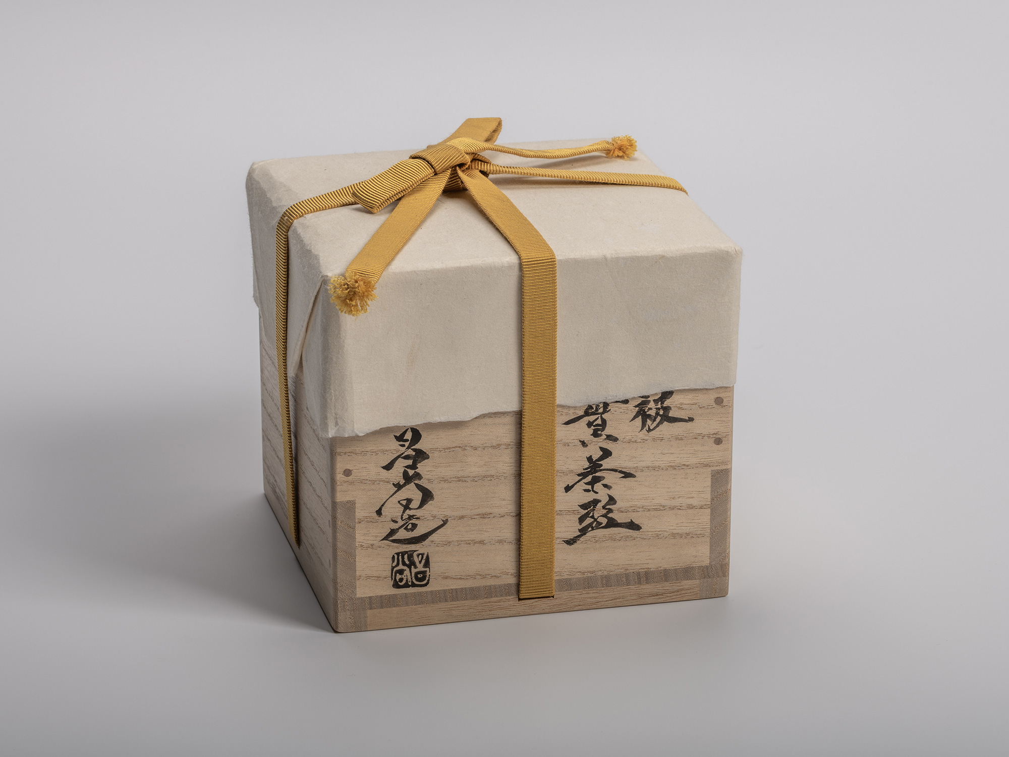 Square wooden presentation box (tomobako) for Masanao Kaneta’s Haikaburi Kurinuki tea bowl, wrapped...