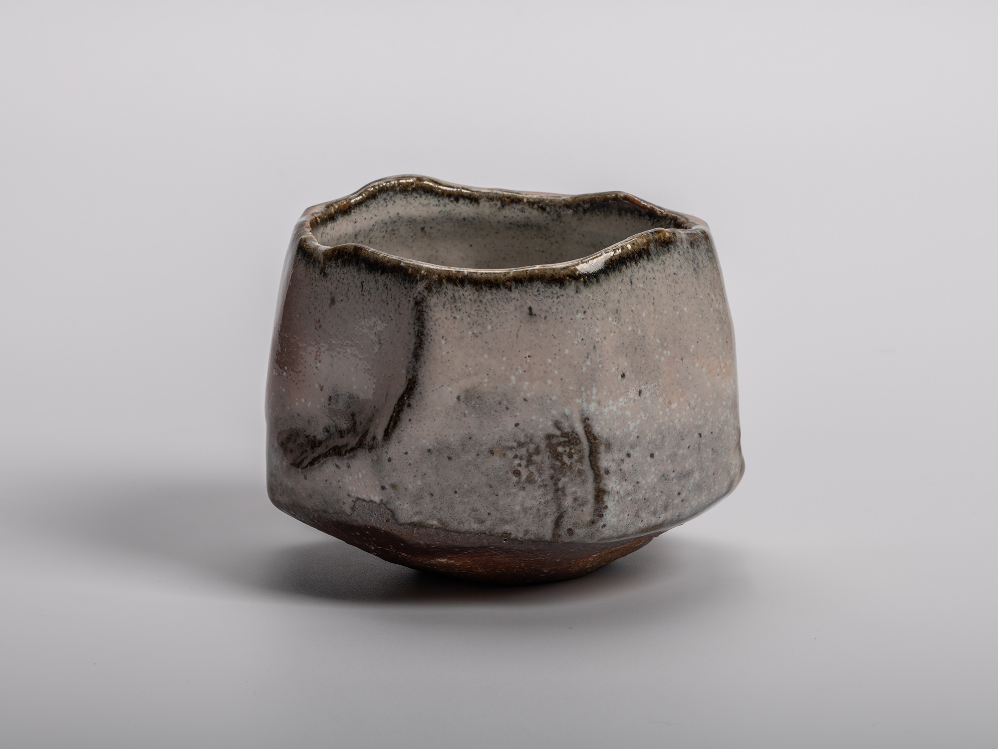 Masanao Kaneta’s Haikaburi Kurinuki tea bowl with hand-carved form, soft ash-fired glaze in gray...