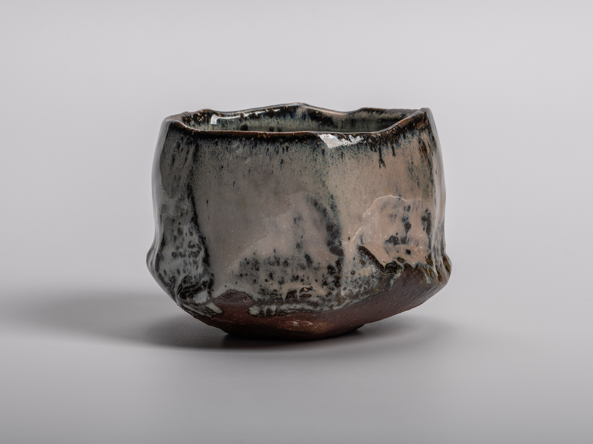 Masanao Kaneta’s Haikaburi Kurinuki tea bowl with hand-carved faceted form, flowing ash-fired glaze...