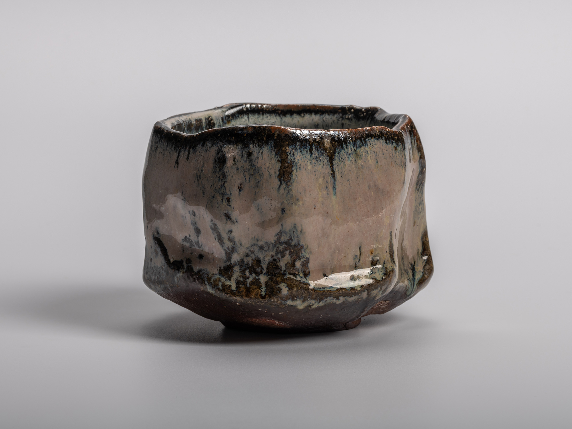 Masanao Kaneta’s Haikaburi Kurinuki tea bowl with hand-carved faceted form, flowing ash-fired glaze...