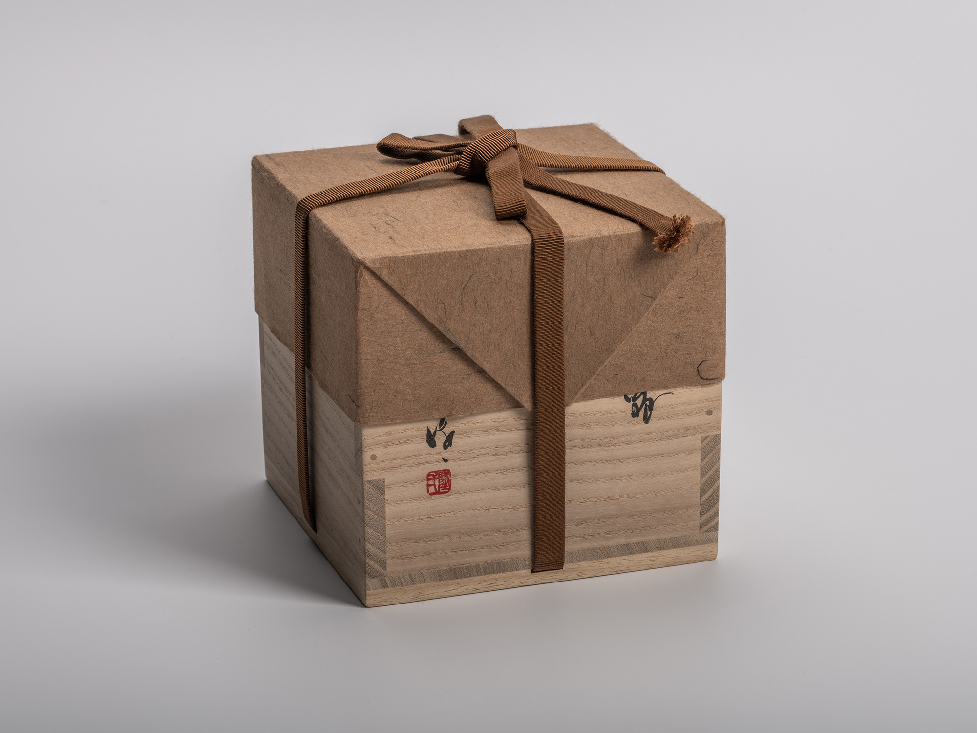 Square wooden tomobako (artist-signed storage box) by ceramic artist Ryuichi Kakurezaki, shown...