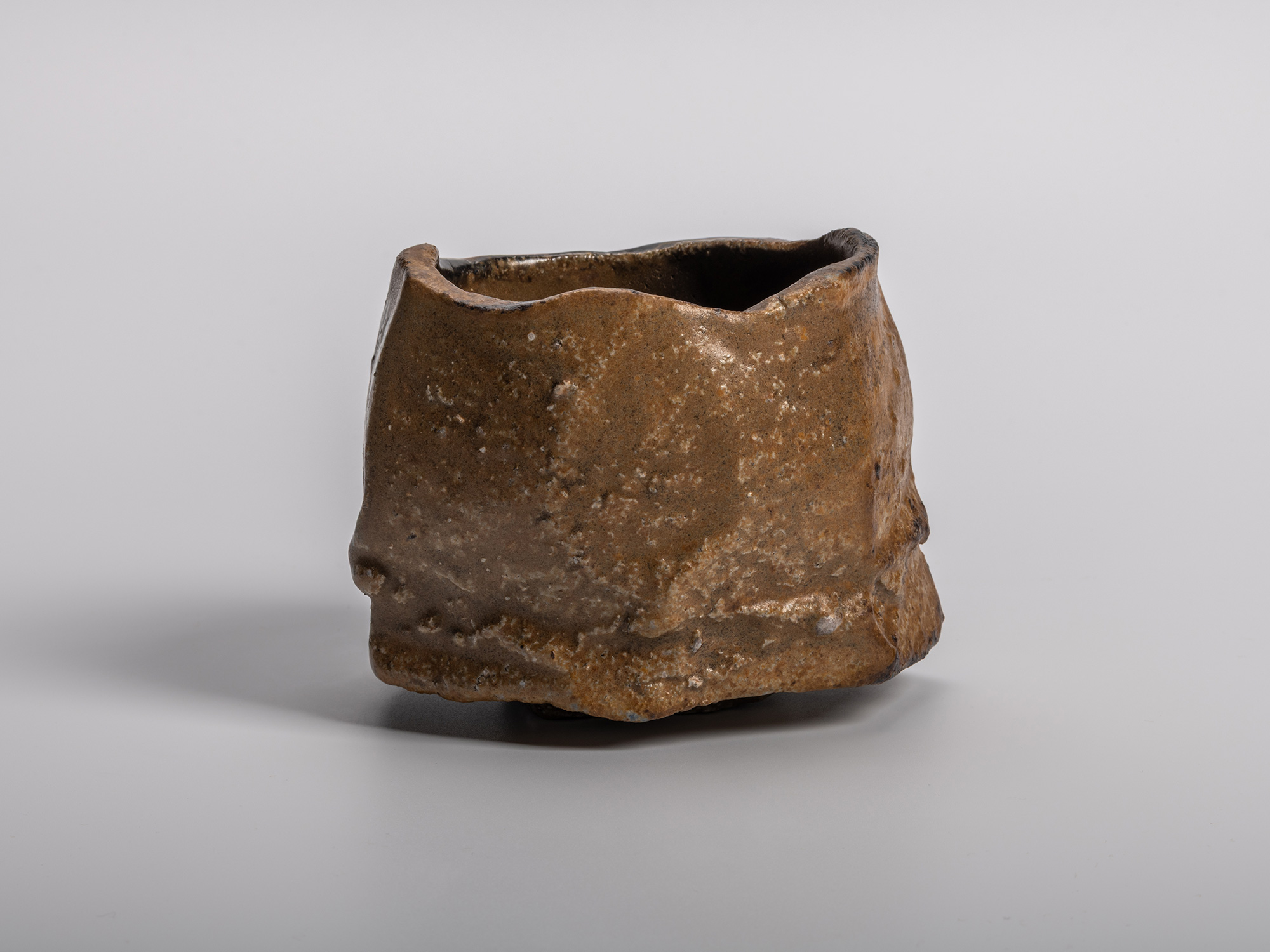 A dramatic, dark-glazed Chamfered Tea Bowl (Tōl Wan) by Bizen ceramic artist Ryuichi Kakurezaki....