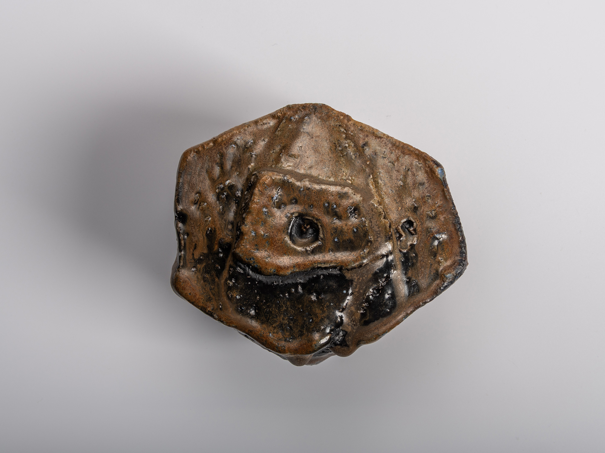 The Foot (kōdai) of a dramatic, dark-glazed Chamfered Tea Bowl (Tōl Wan) by Bizen ceramic artist...