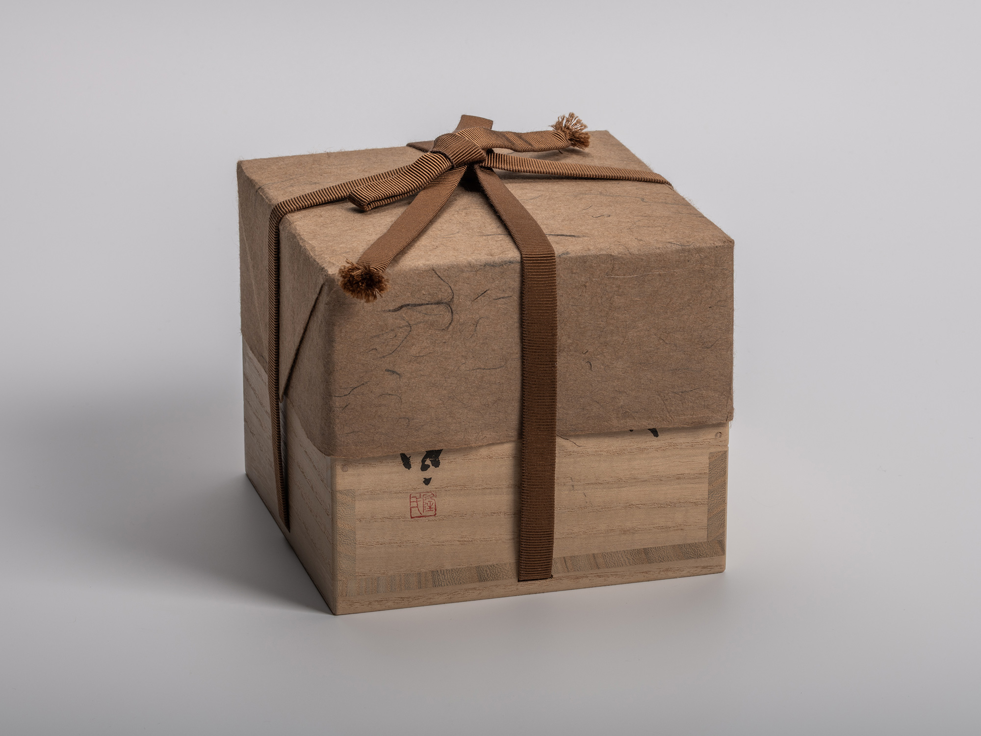 Square tomobako (artist-signed storage box) for the Konko Black Tea Bowl, half-wrapped in natural...