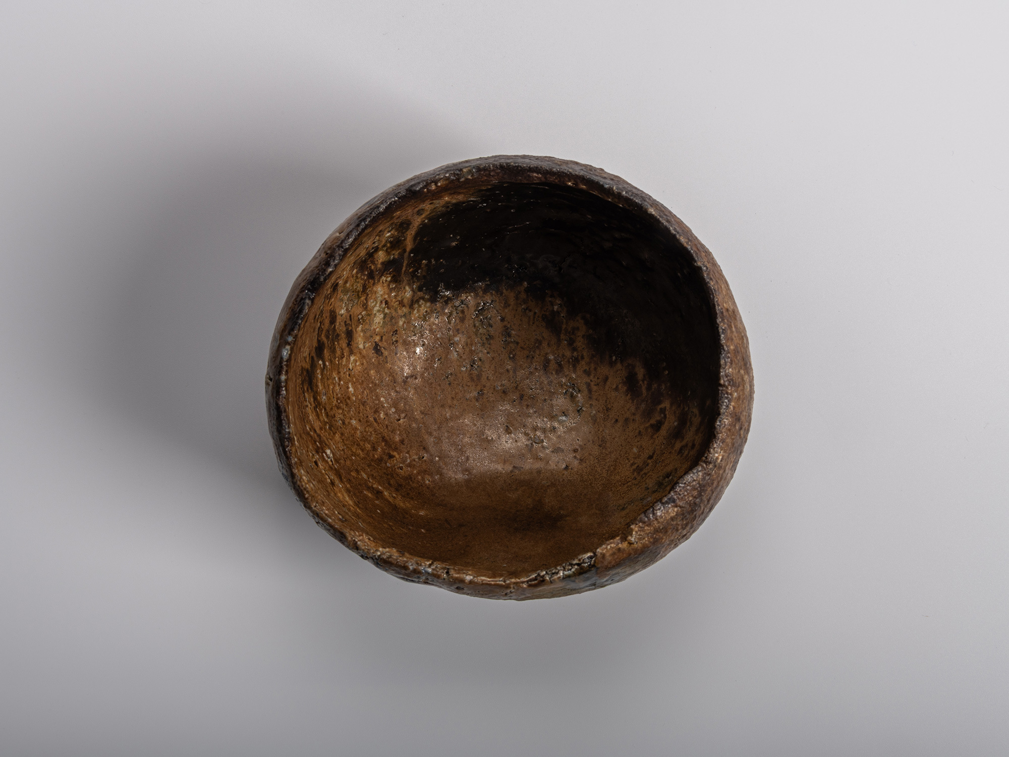 Image of interior (mikomi) of a sculptural Konko black tea bowl by Ryuichi Kakurezaki featuring...