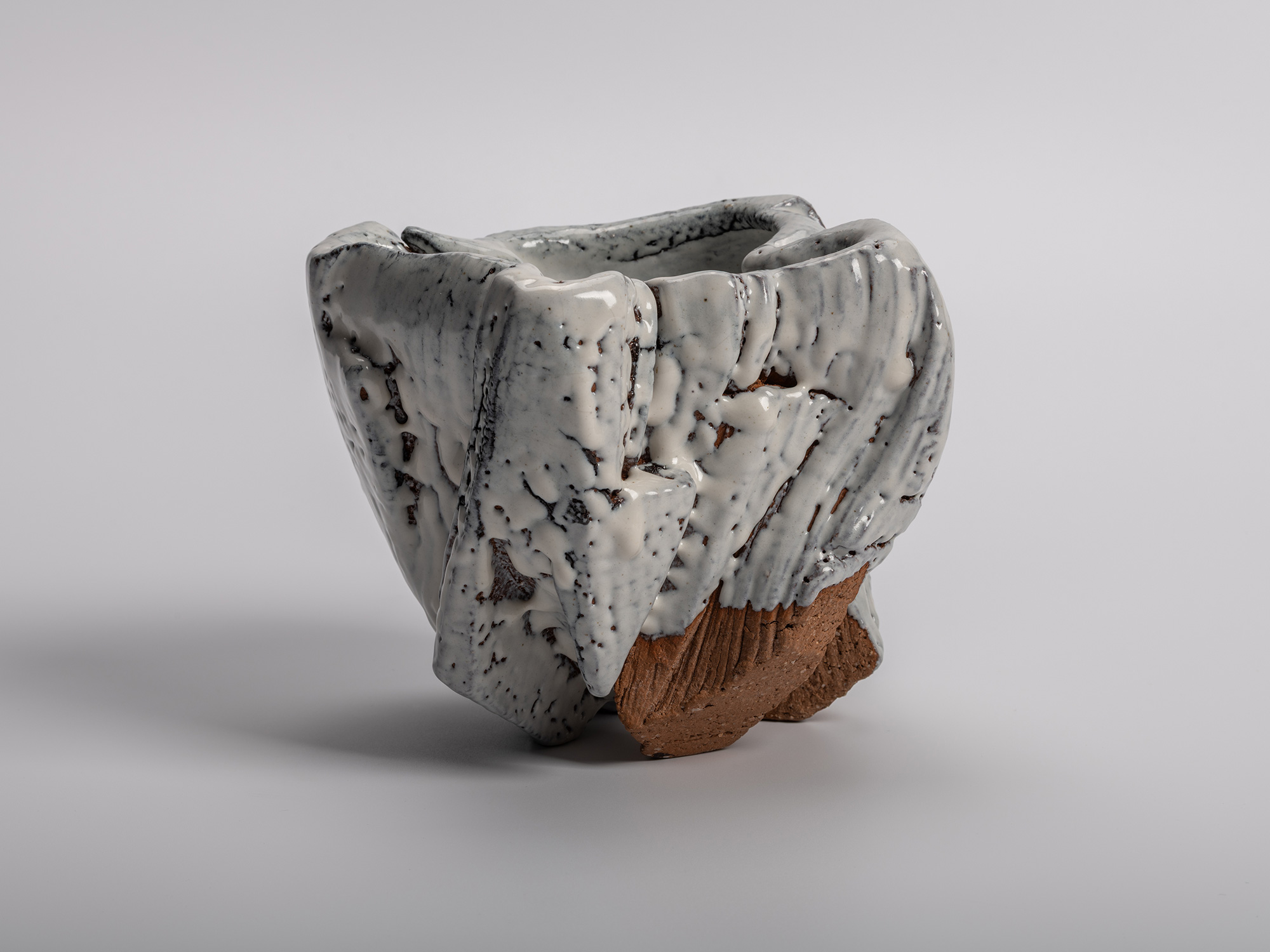 El Capitan tea bowl by Miwa Kyusetsu III, featuring a sculptural carved form with flowing white...