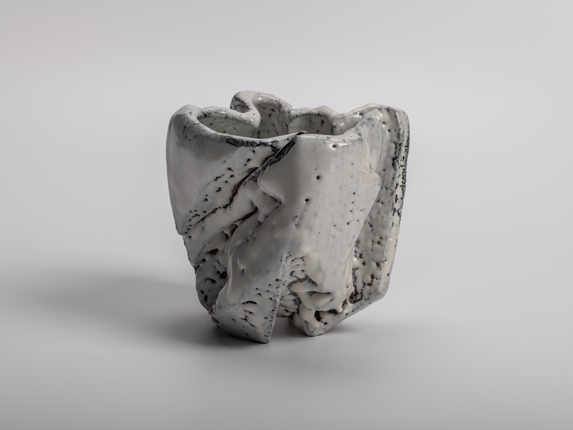 El Capitan tea bowl by Miwa Kyusetsu III, featuring a sculptural carved form with flowing white...