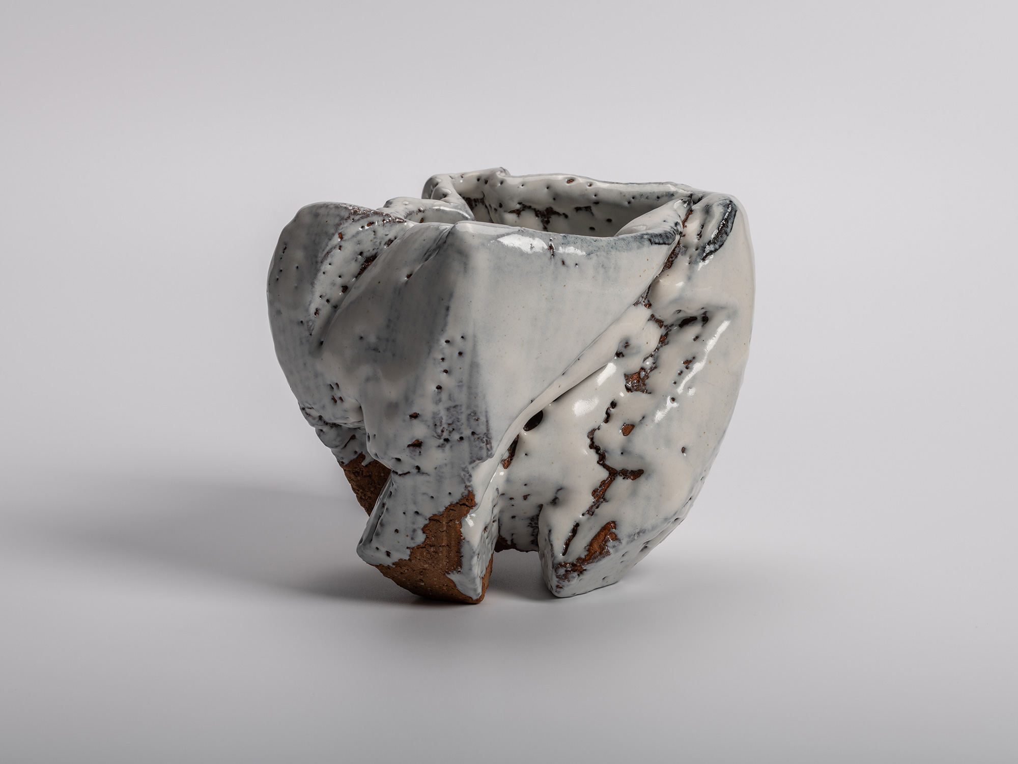 El Capitan tea bowl by Miwa Kyusetsu III, featuring a sculptural carved form with flowing white...