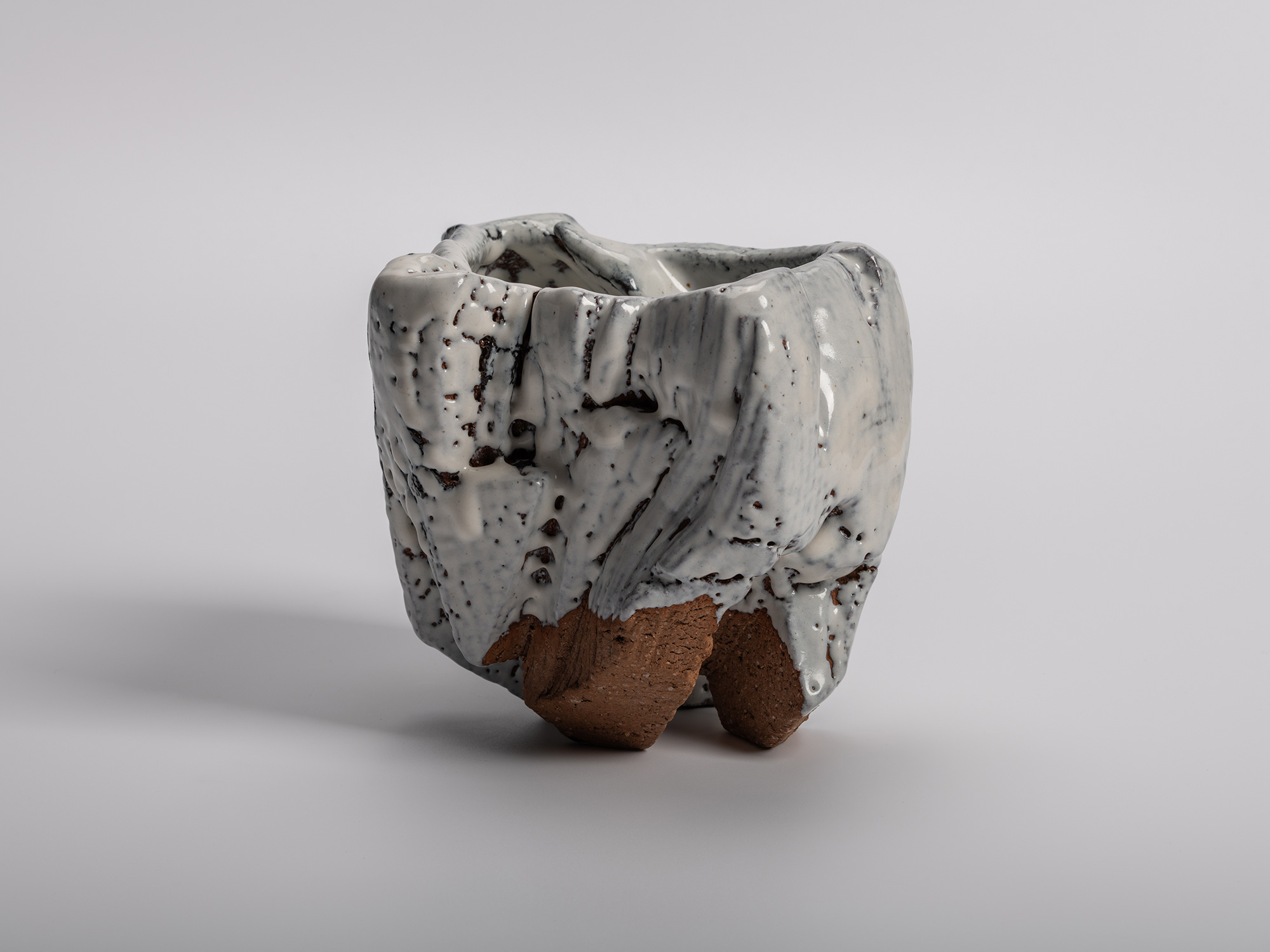 El Capitan tea bowl by Miwa Kyusetsu III, featuring a sculptural carved form with flowing white...
