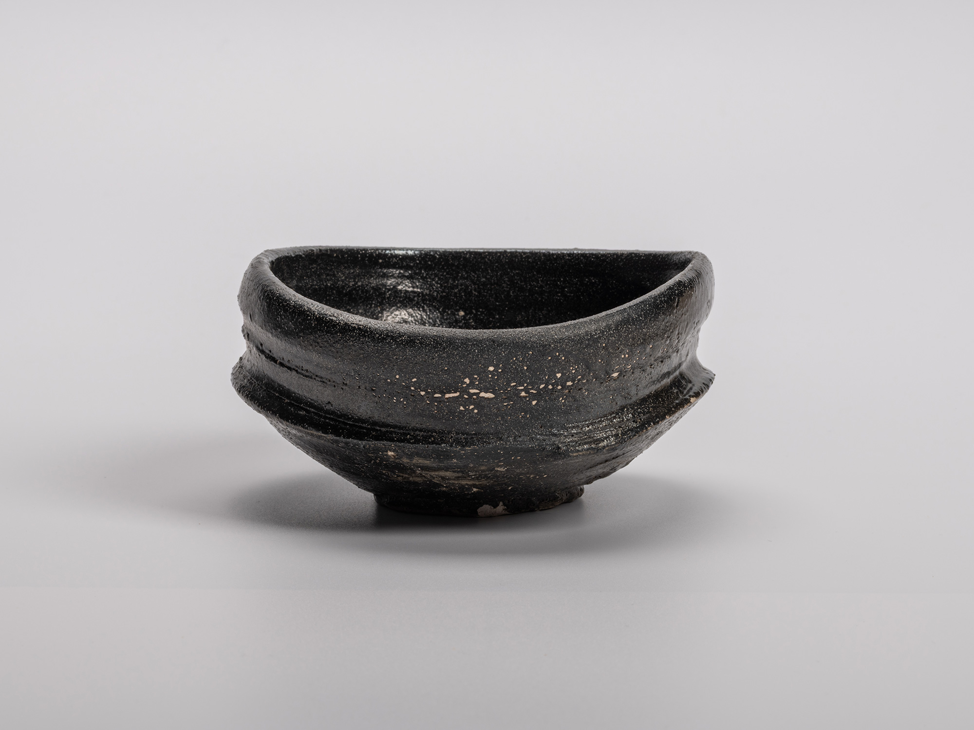 Oribe Kuro Chawan by Shiro Tsujimura, a hand-formed black tea bowl with layered glaze textures...