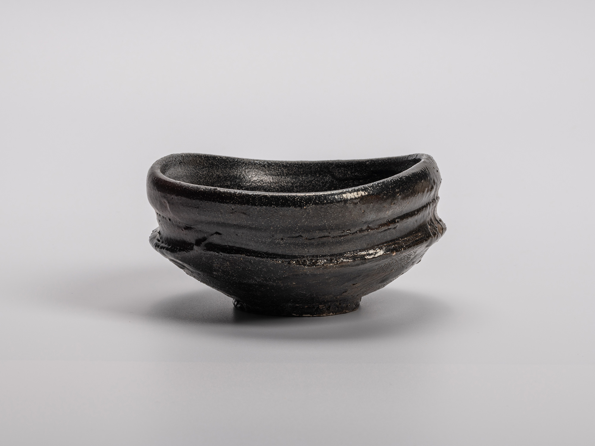 Oribe Kuro Chawan by Shiro Tsujimura, a hand-formed black tea bowl with layered glaze textures...
