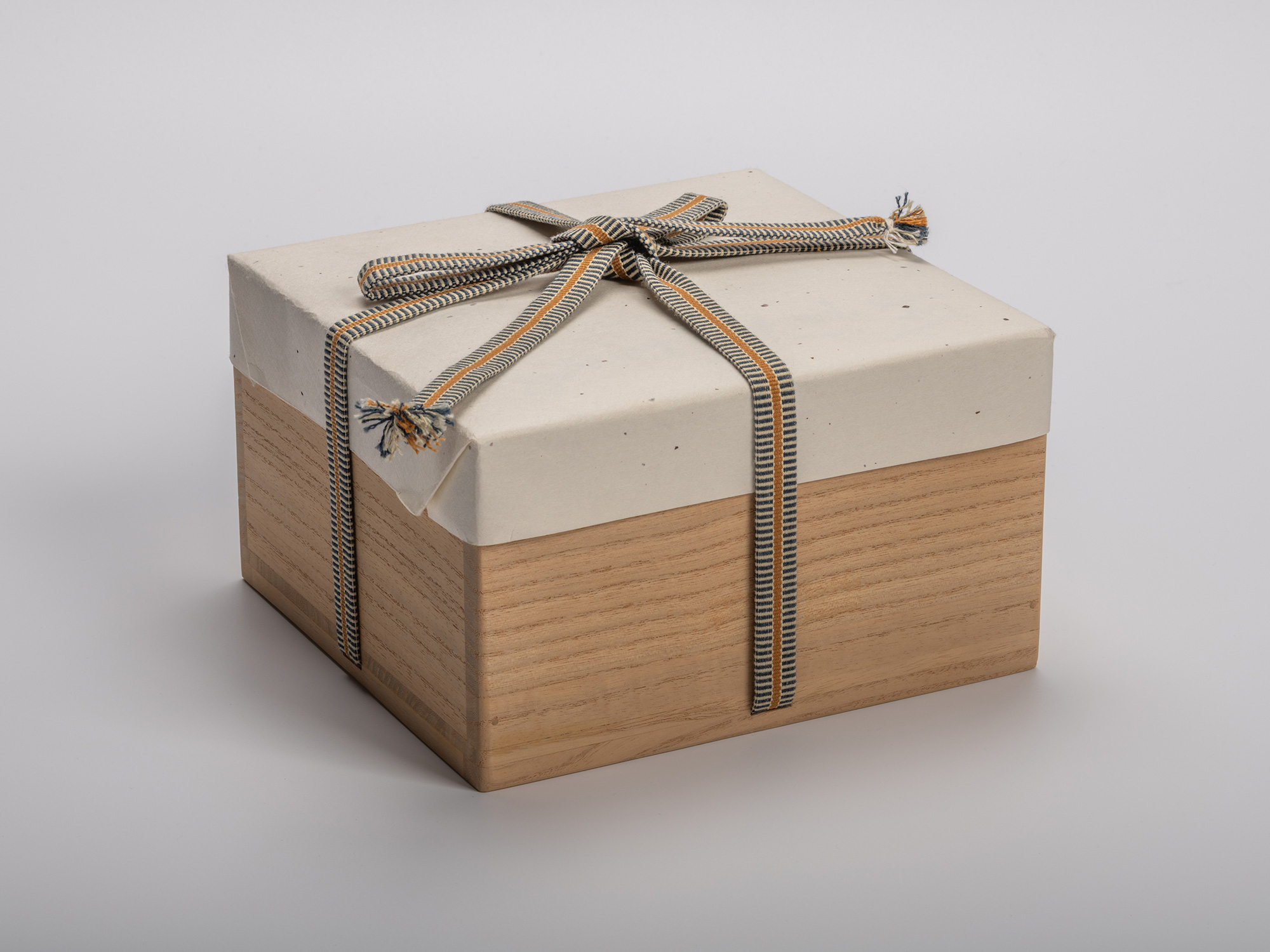 Rectangular wooden tomobako (artist-signed storage box) by ceramic artist, shown with its gold...