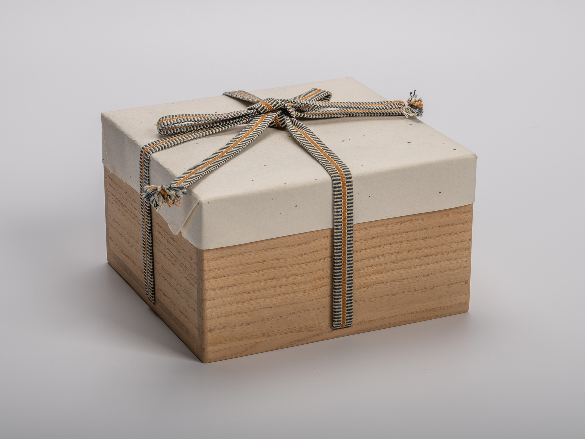 Square wooden tomobako (artist-signed storage box) by ceramic artist, shown with its gold and black...