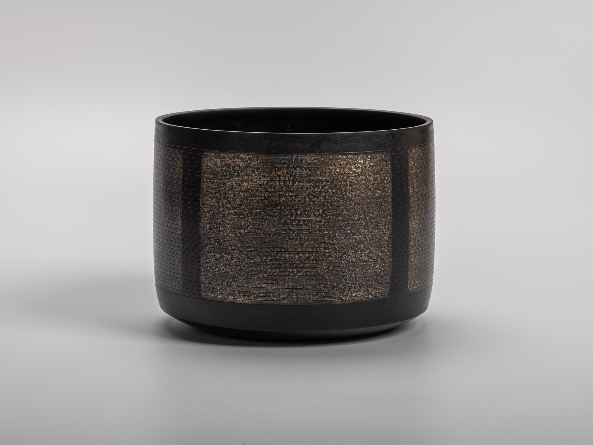 Sahari Water Jug by Uozumi Iraku III, a refined metal vessel with textured bronze panels without...