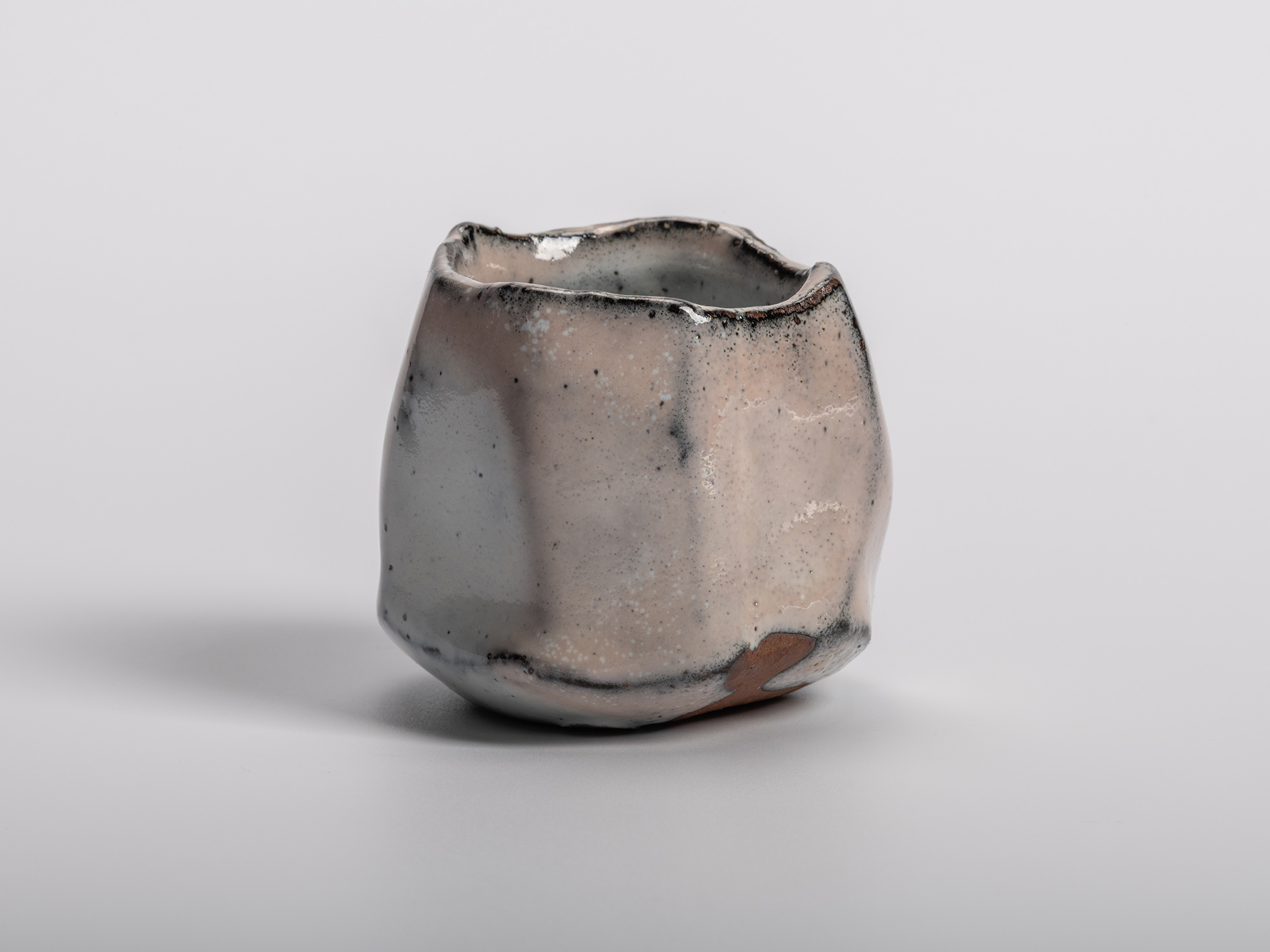 Masanao Kaneta’s White Glaze Youhen Kurinuki Guinomi with hand-carved sculptural form, soft white...