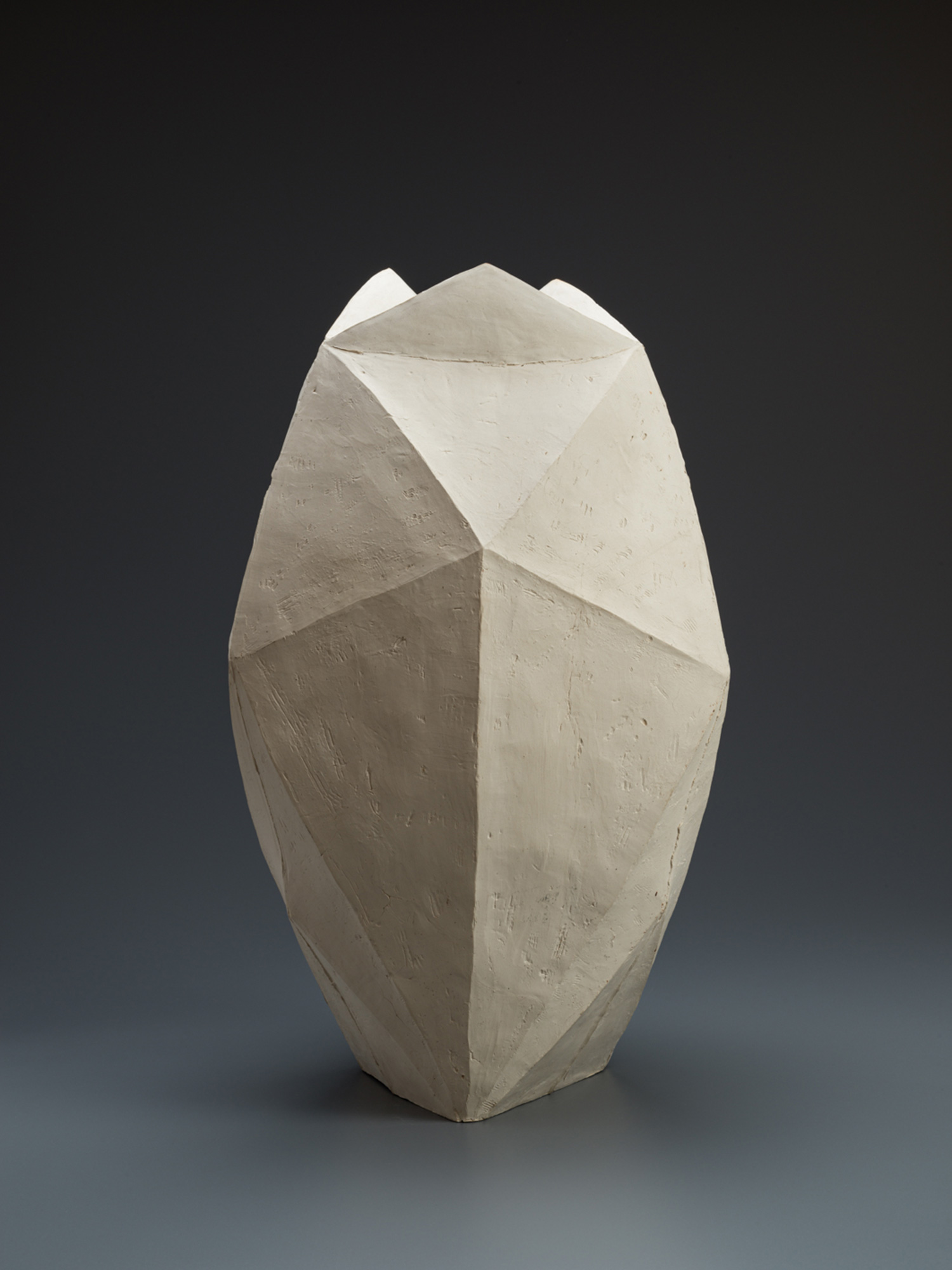 White multifaceted ceramic vase by Mori Tōgaku with sharply folded, paper-like planes and a matte...