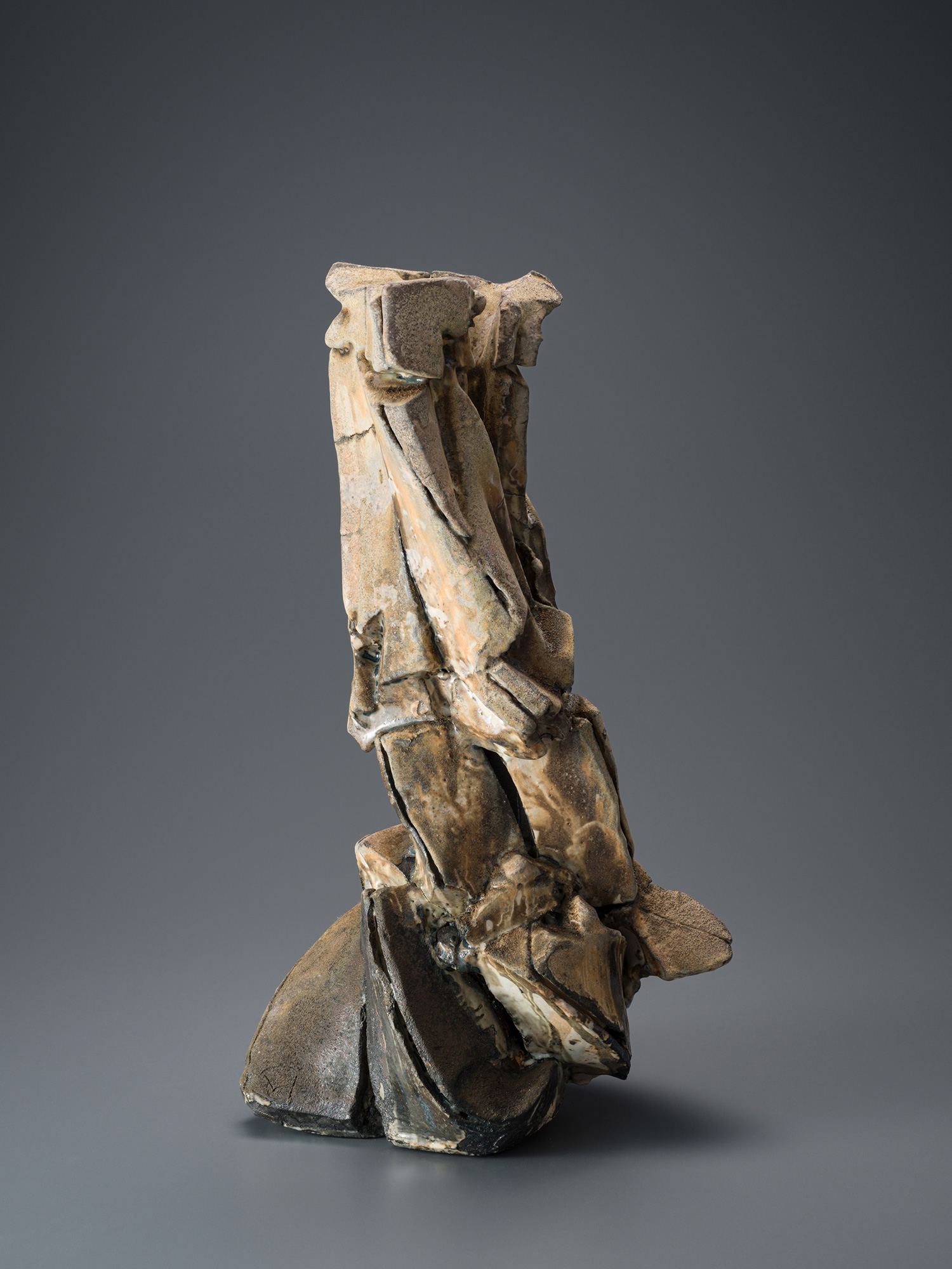 Vertical ceramic sculpture by Shōzō Michikawa featuring angular, folded planes and compressed forms,...