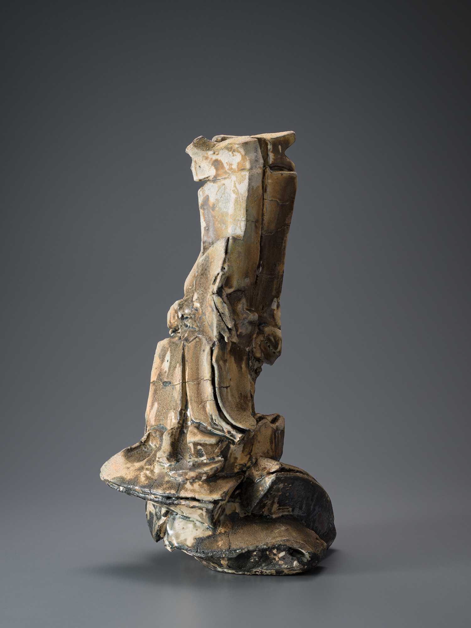 Vertical ceramic sculpture by Shōzō Michikawa featuring angular, folded planes and compressed forms,...