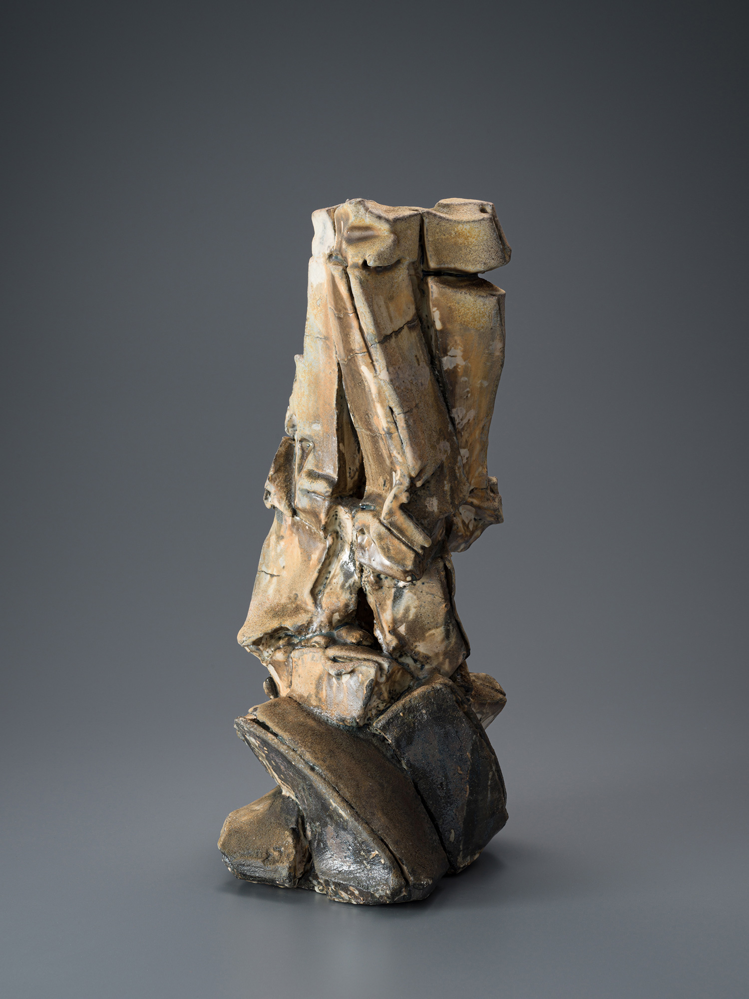 Vertical ceramic sculpture by Shōzō Michikawa featuring angular, folded planes and compressed forms,...