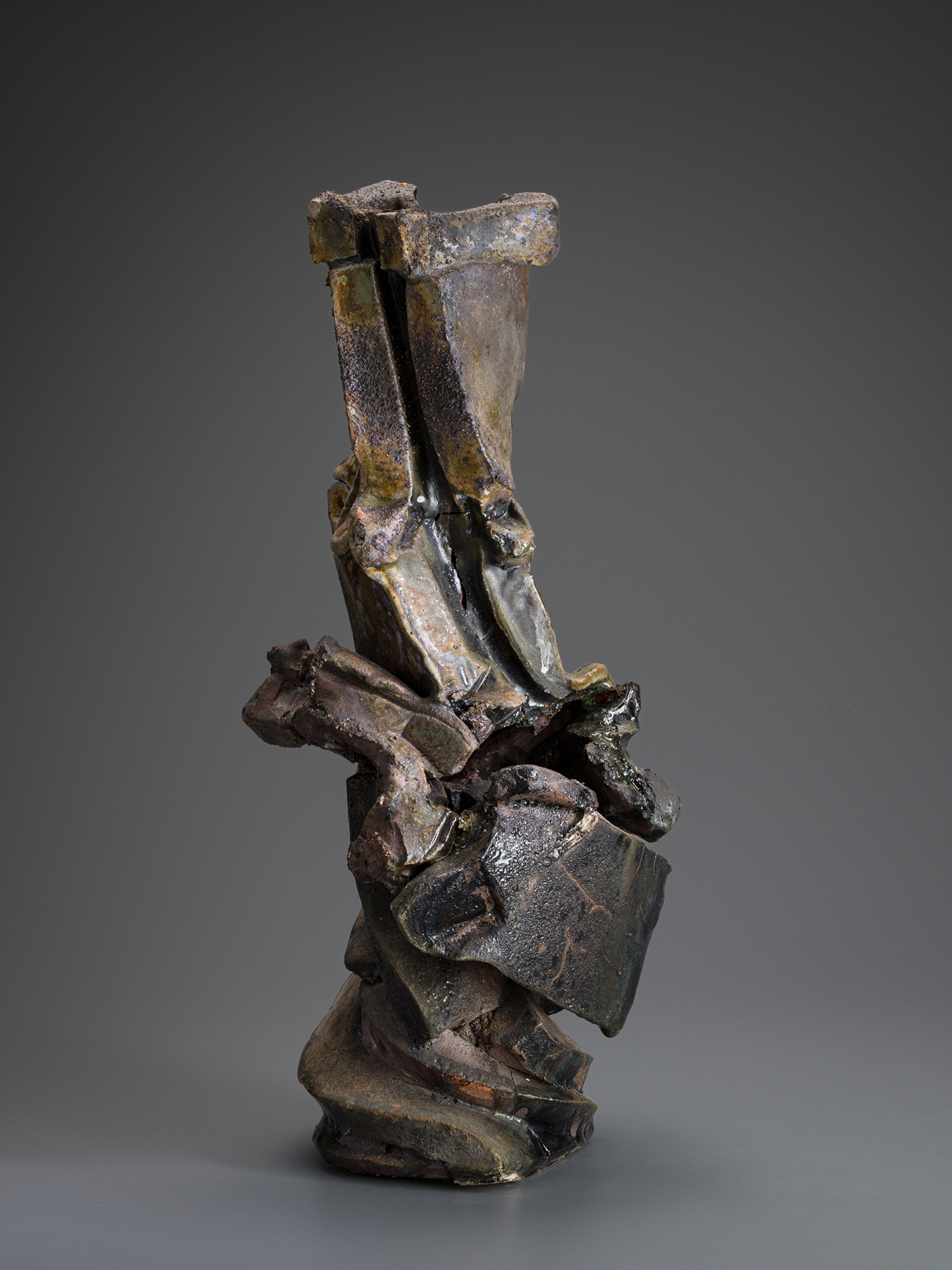 Vertical ceramic sculpture titled Volcano by Shōzō Michikawa, composed of stacked, fractured planes...