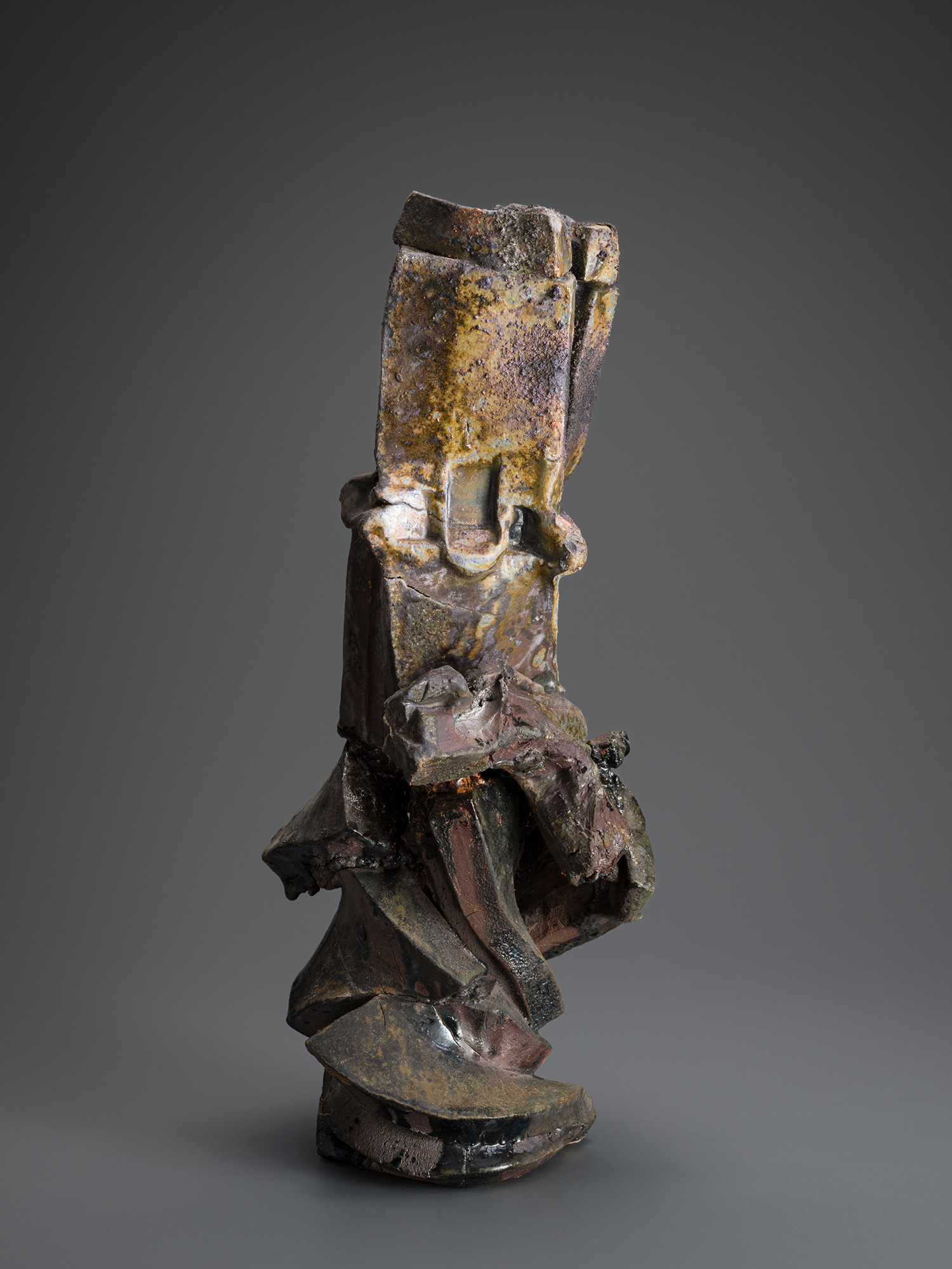 Vertical ceramic sculpture titled Volcano by Shōzō Michikawa, composed of stacked, fractured planes...