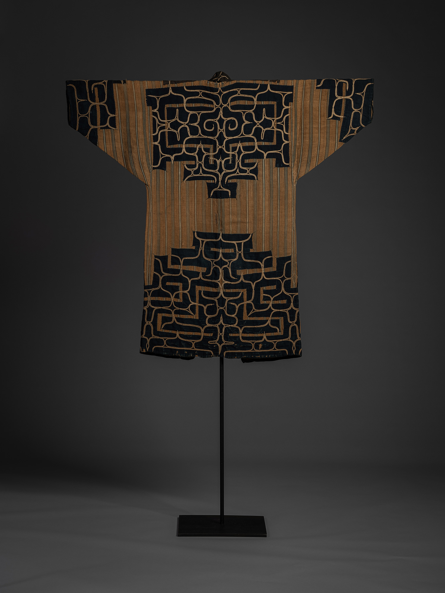 Back of mid-19th-century Ainu attush robe made of woven elm bark fiber, displayed frontally on...