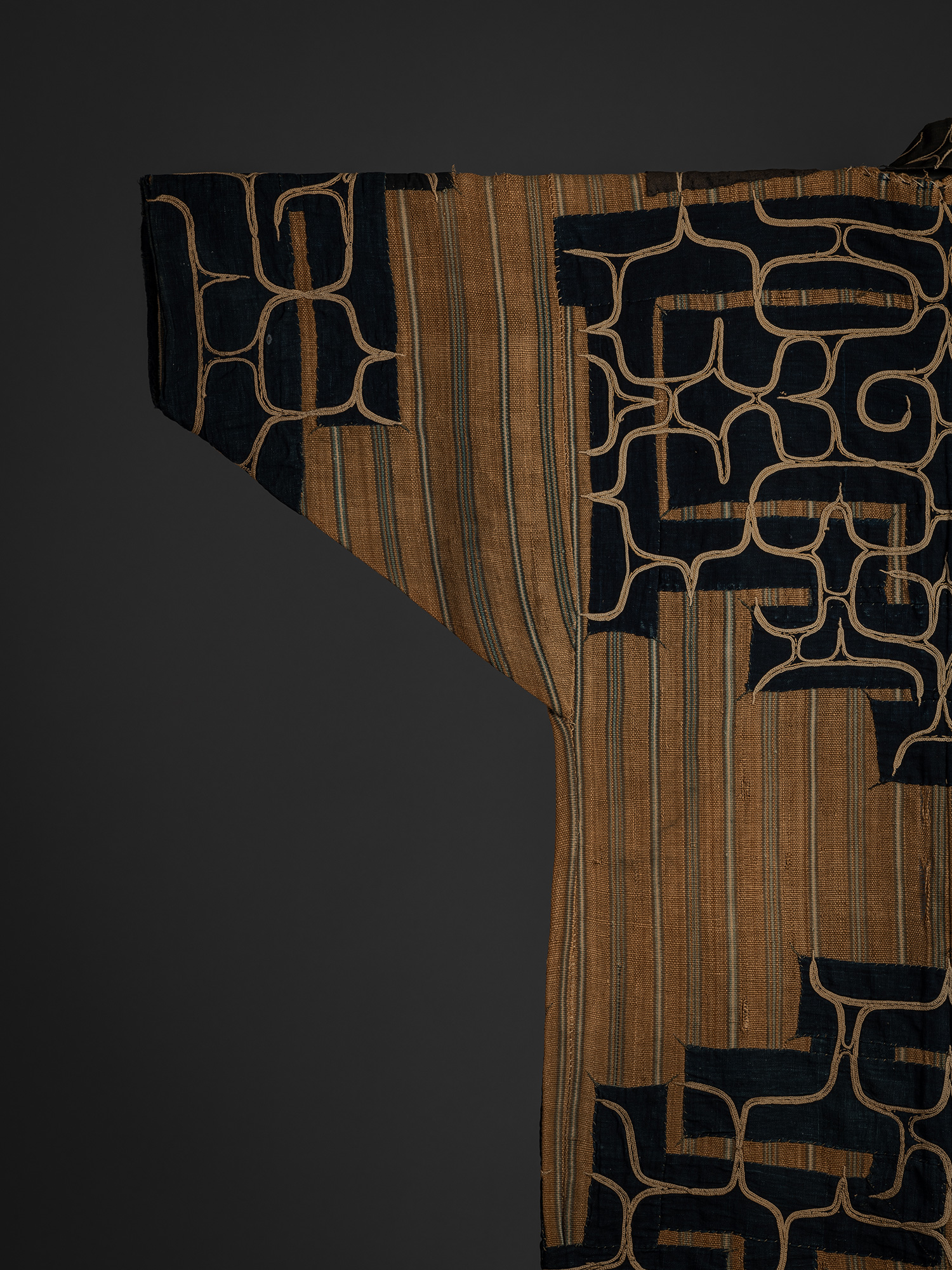 Detail of the back left sleeve of a mid-19th-century Ainu attush robe, showing indigo-dyed cotton...