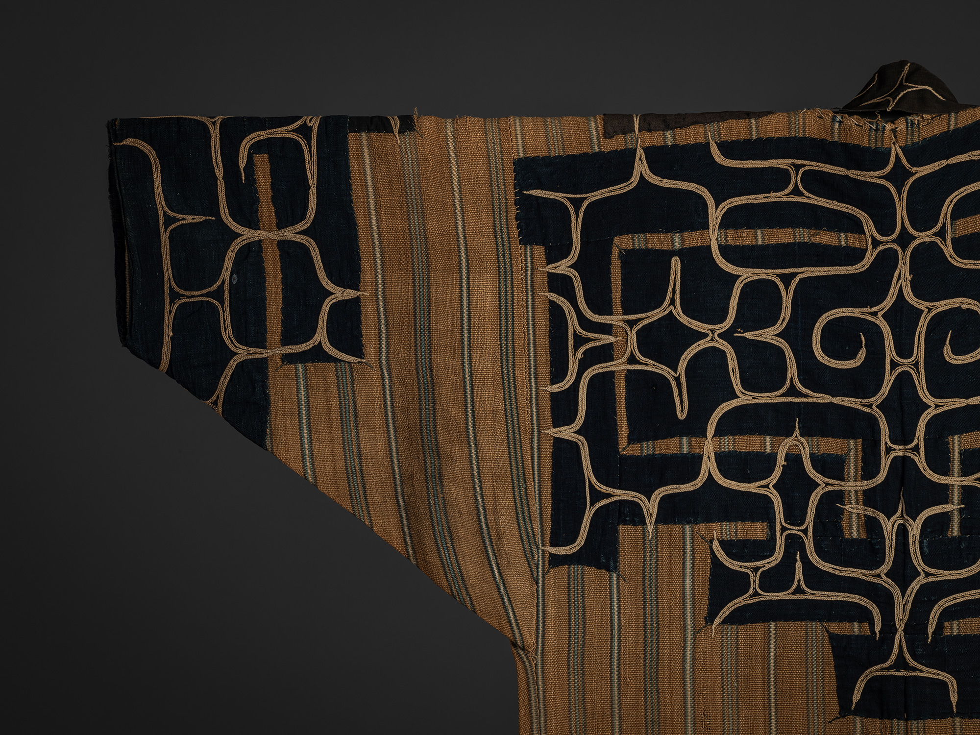 Detail of the back left sleeve of a mid-19th-century Ainu attush robe, showing indigo-dyed cotton...