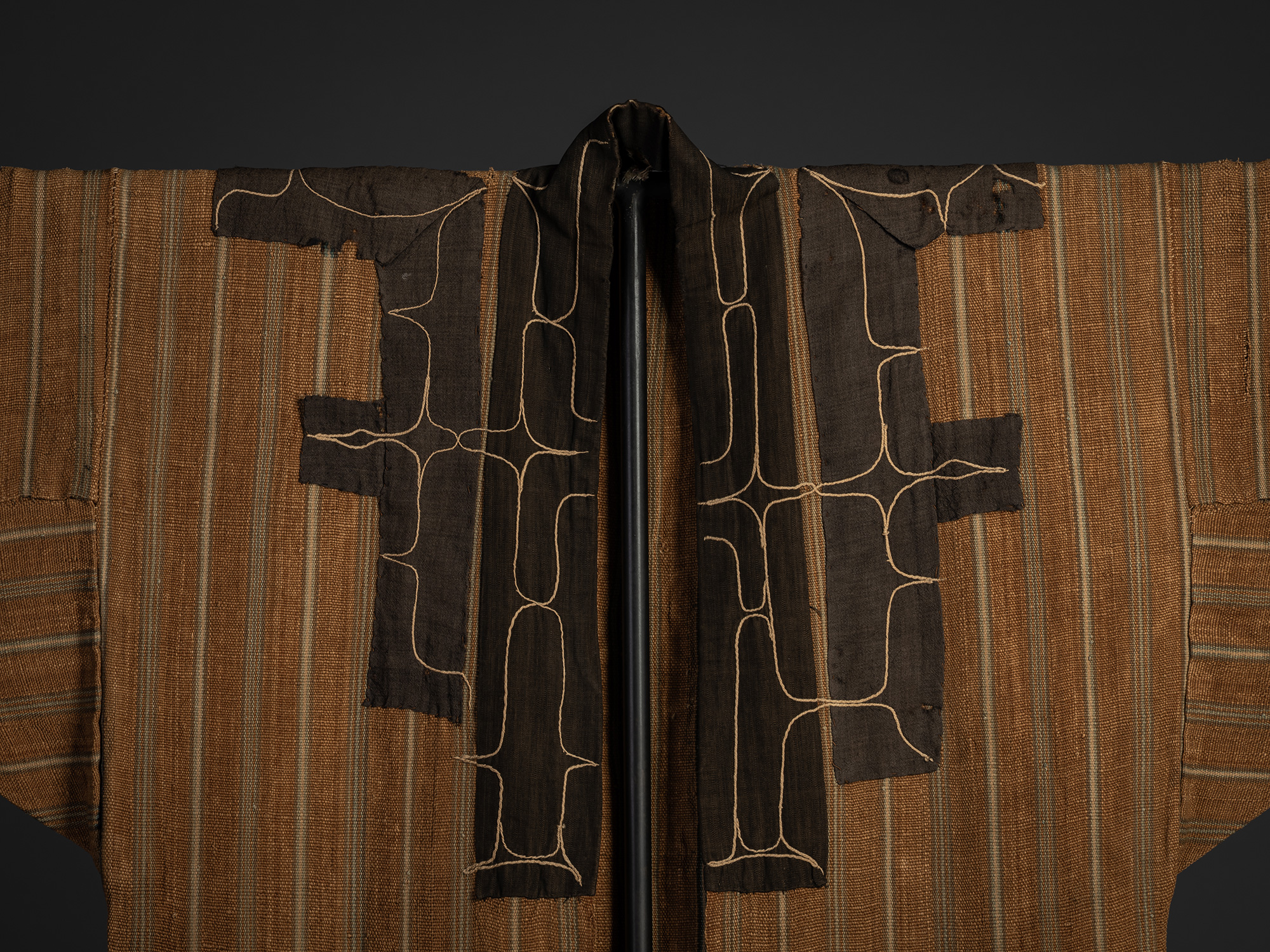 Detail of the collar of a mid-19th-century Ainu attush robe, showing indigo-dyed cotton appliqué...