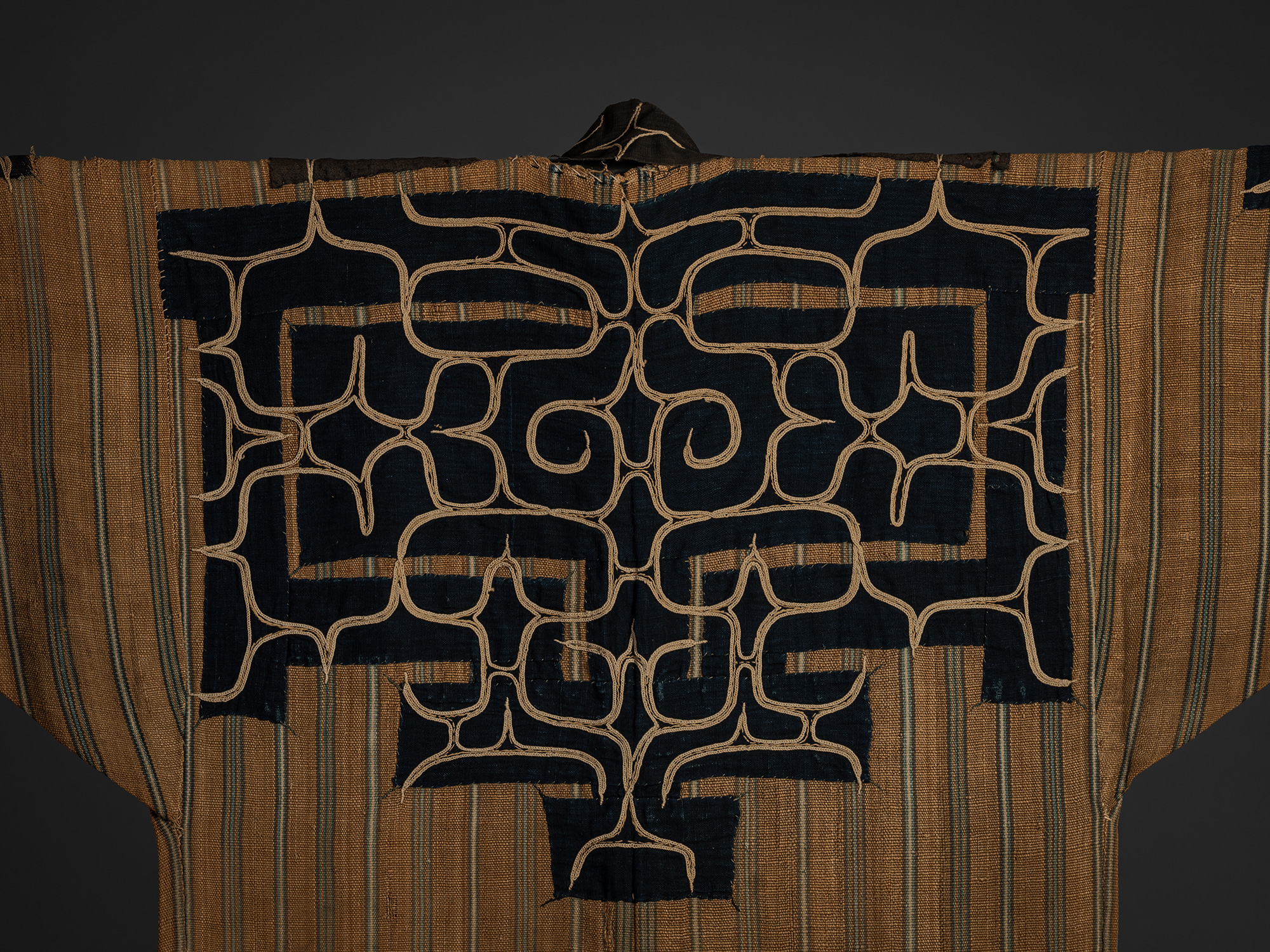 Detail of the back shoulder blades of a mid-19th-century Ainu attush robe, showing indigo-dyed...