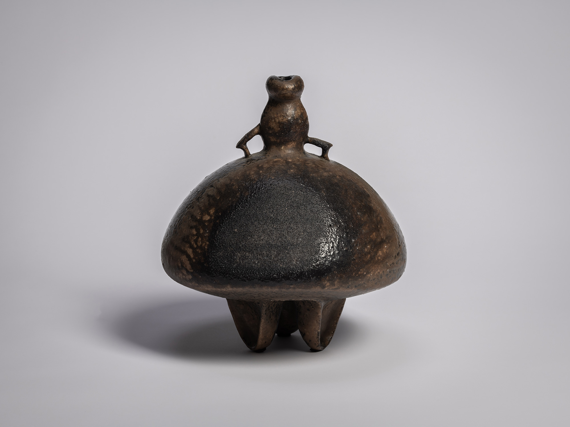 Black glazed sculptural ceramic vessel by Ryuichi Kakurezaki, featuring a bulbous domed body, small...
