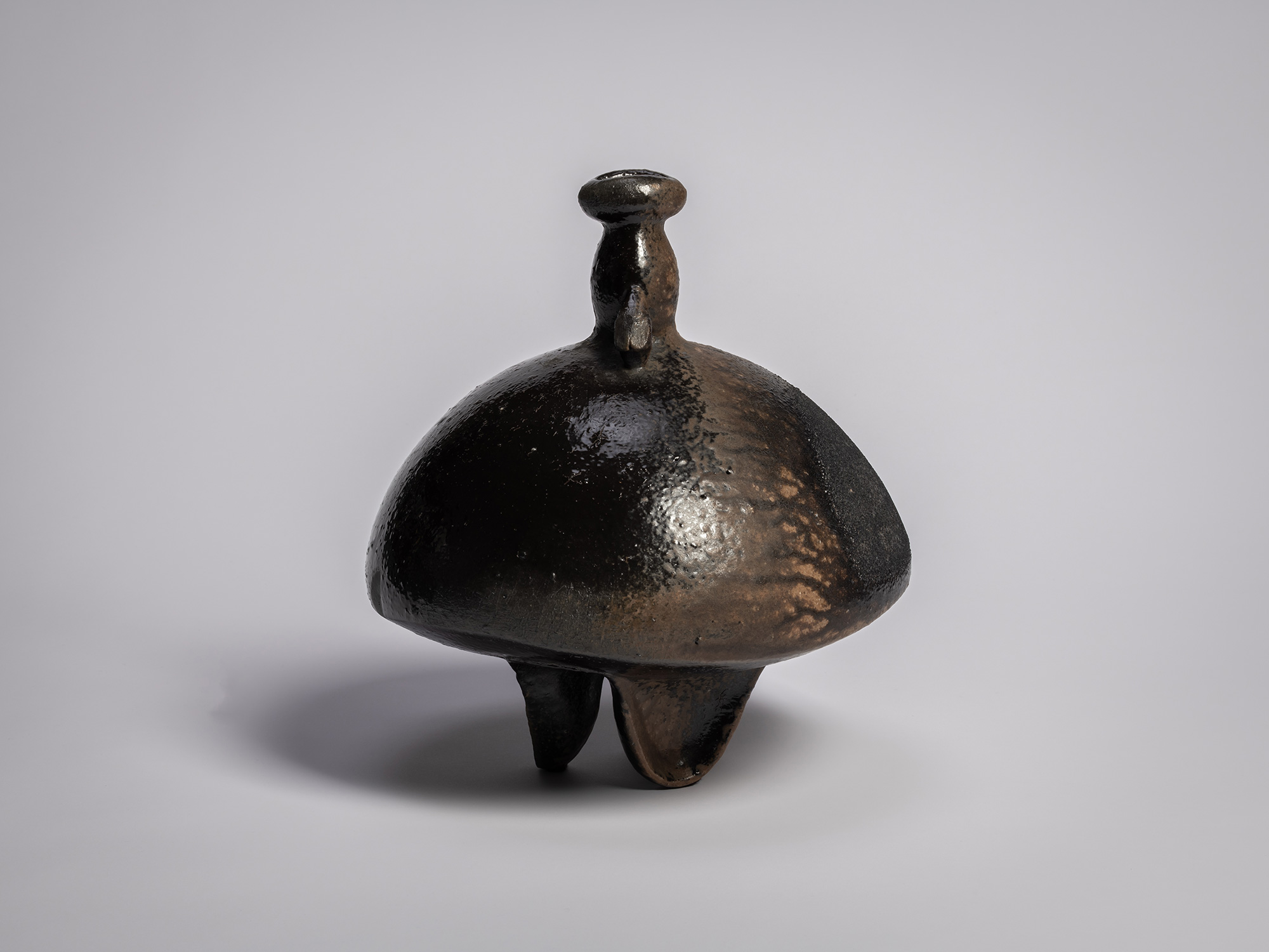 Black glazed sculptural ceramic vessel by Ryuichi Kakurezaki, featuring a bulbous domed body, small...