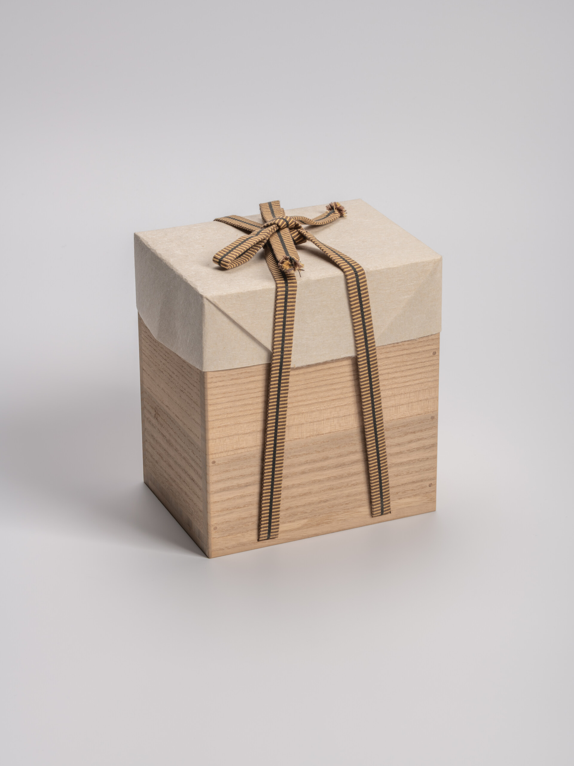 Rectangular wooden tomobako (artist-signed storage box) by ceramic artist, shown with its tan carrying...