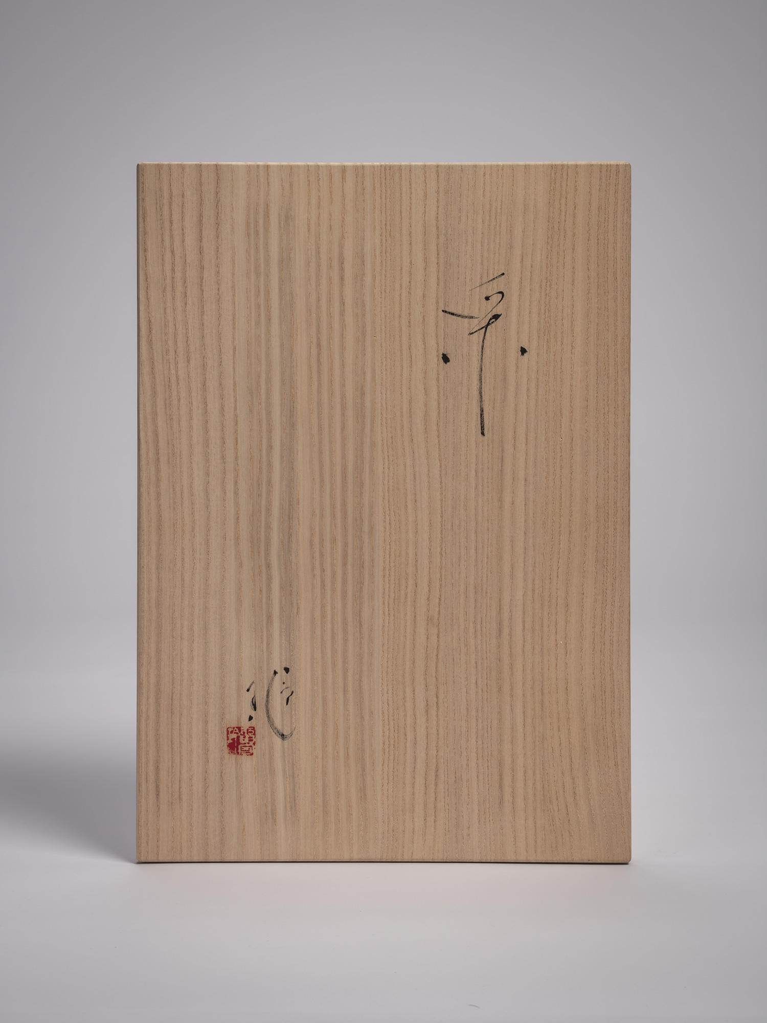 Wooden tomobako storage box for Étranger by Aki Rusu, featuring pale kiri wood with sparse black...