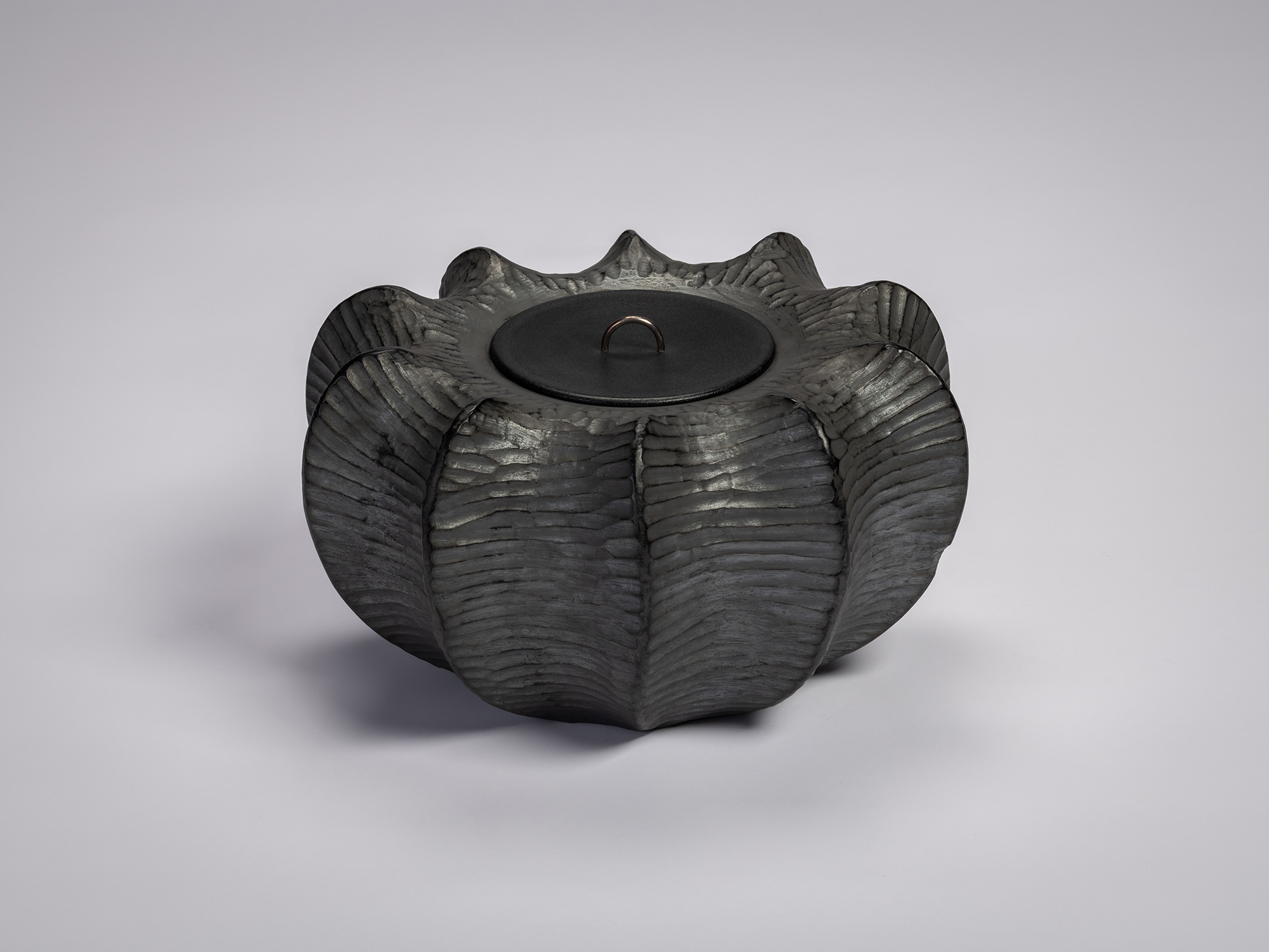 Front view of the Furrowed Black Zelkova Water Jar by Jihei Murase, a lacquered vessel with a sculptural,...