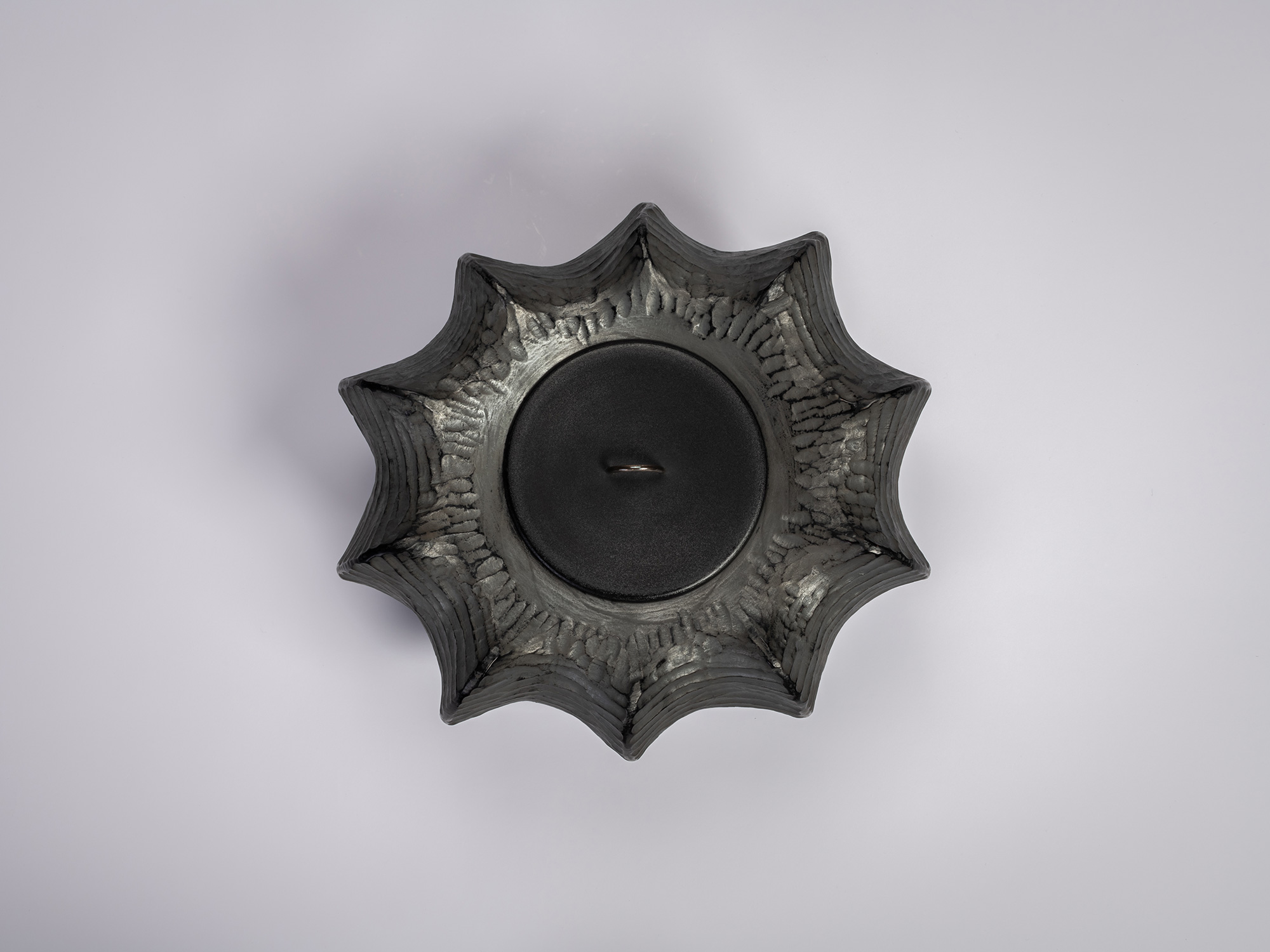 Aerial view of the Furrowed Black Zelkova Water Jar by Jihei Murase, a lacquered vessel with a...