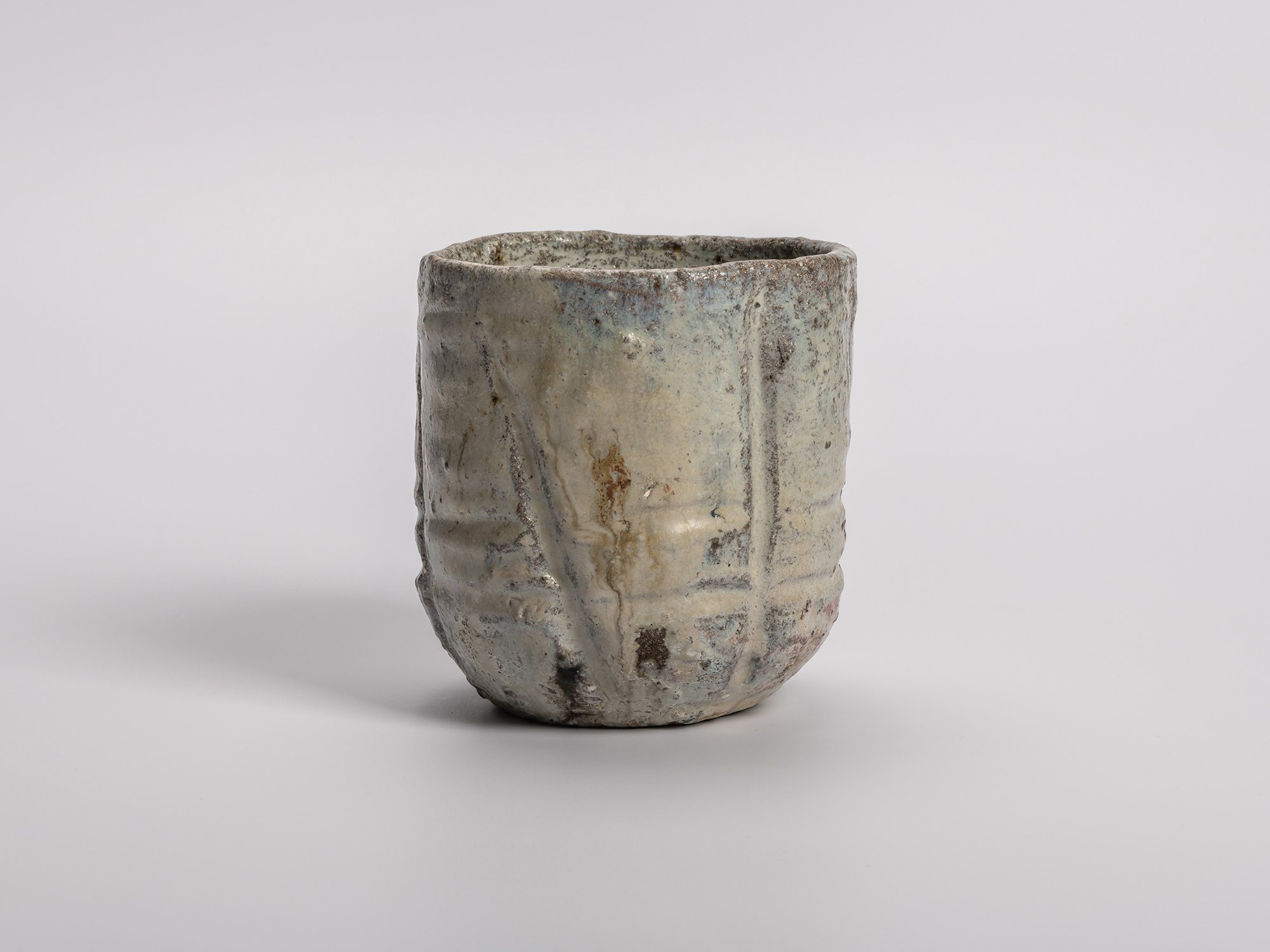 Handmade (tezukuri) tea bowl (chawan) by Shiro Tsujimura, shown upright, with a cylindrical, hand-built...