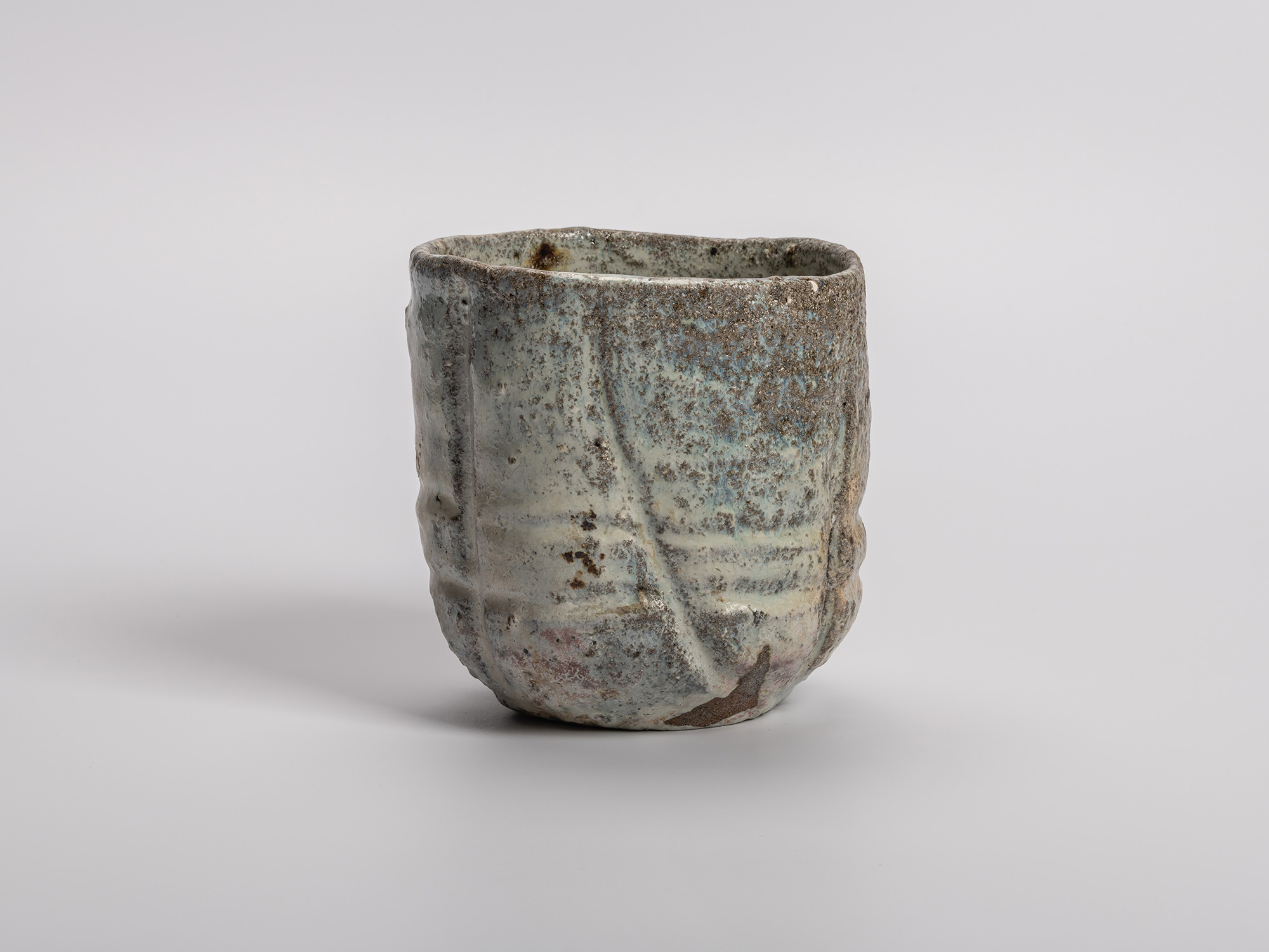 Handmade (tezukuri) tea bowl (chawan) by Shiro Tsujimura, shown upright, with a cylindrical, hand-built...