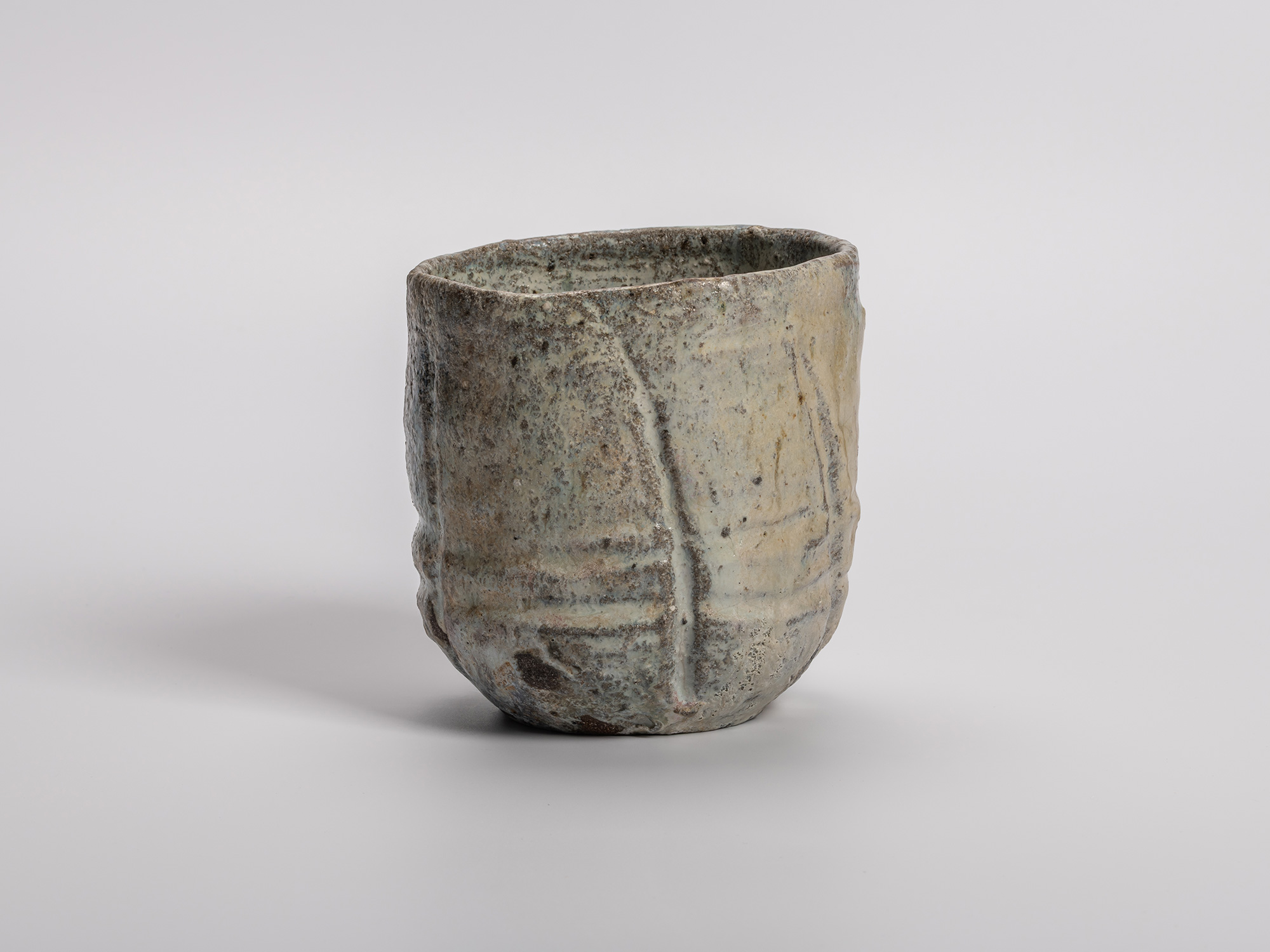 Handmade (tezukuri) tea bowl (chawan) by Shiro Tsujimura, shown upright, with a cylindrical, hand-built...