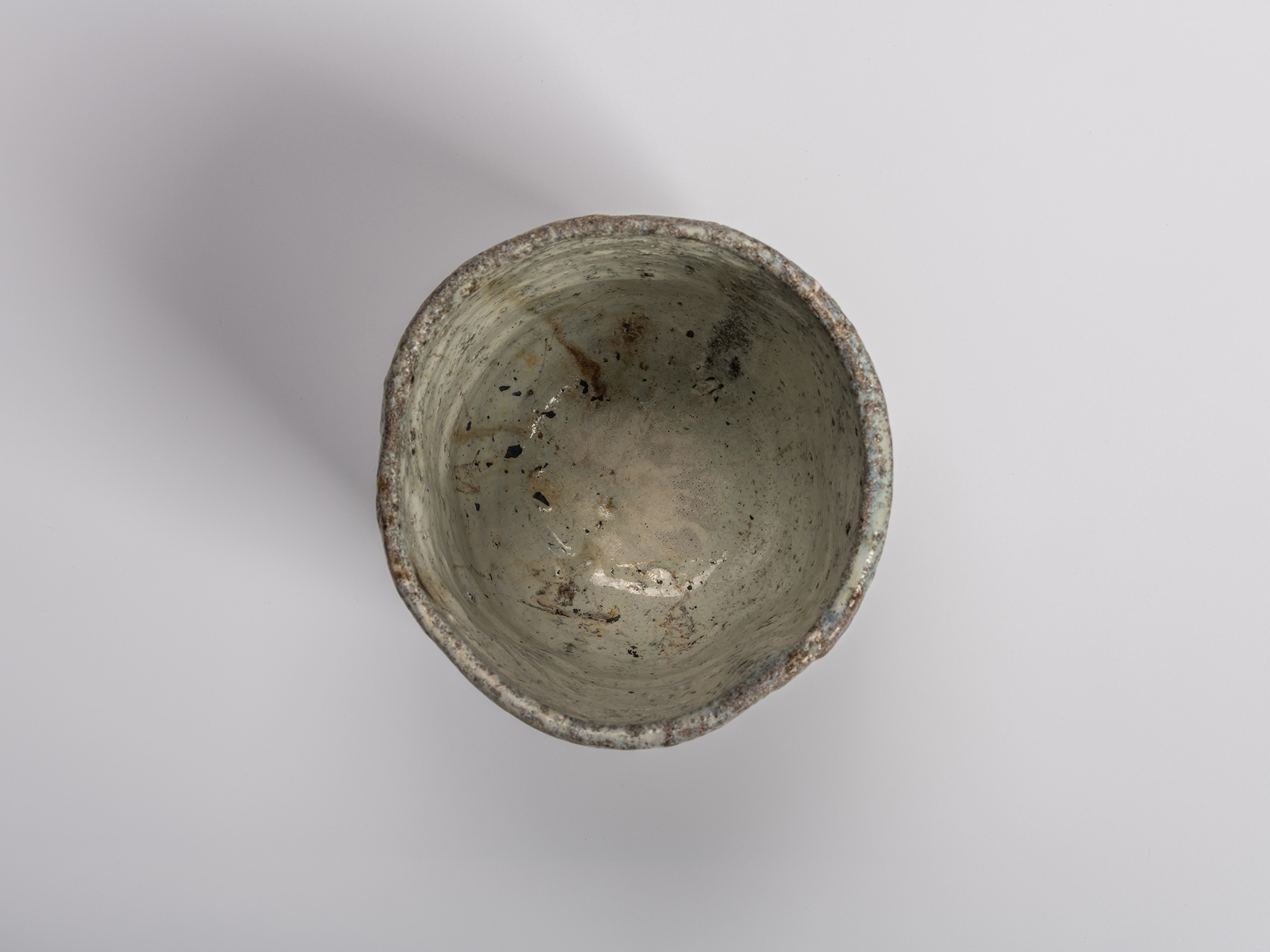 Interior (mikomi) view of a handmade (tezukuri) Gen’emon kiln tea bowl by Shiro Tsujimura, showing...