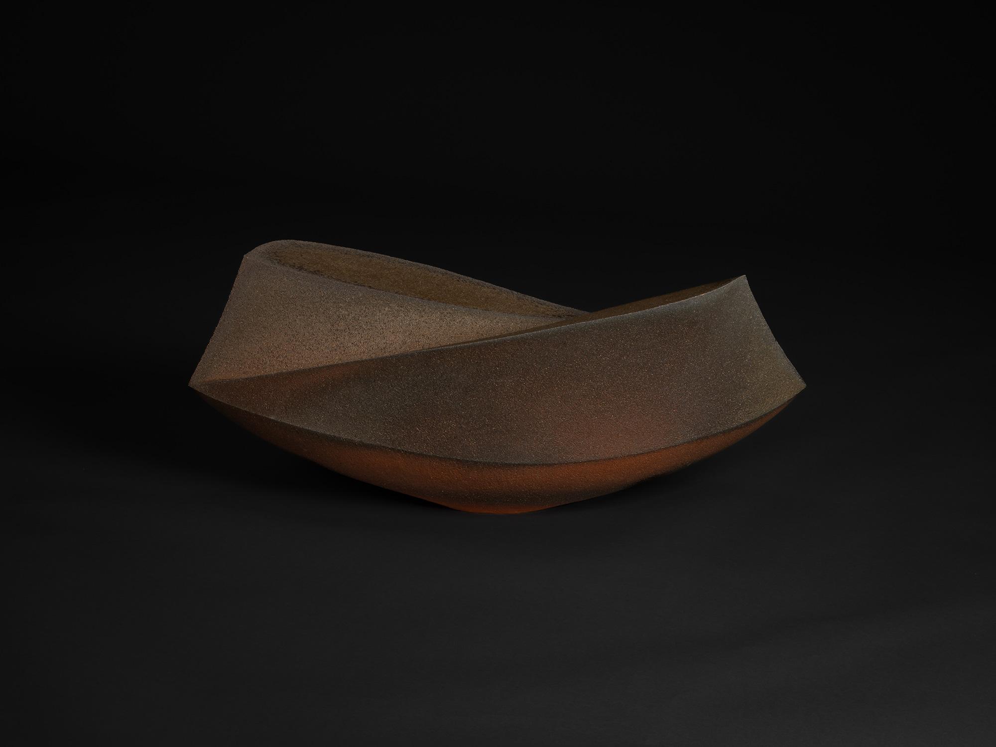 Ceramic sculpture by Shunichi Yabe featuring an elongated, angular vessel form with sharply faceted...