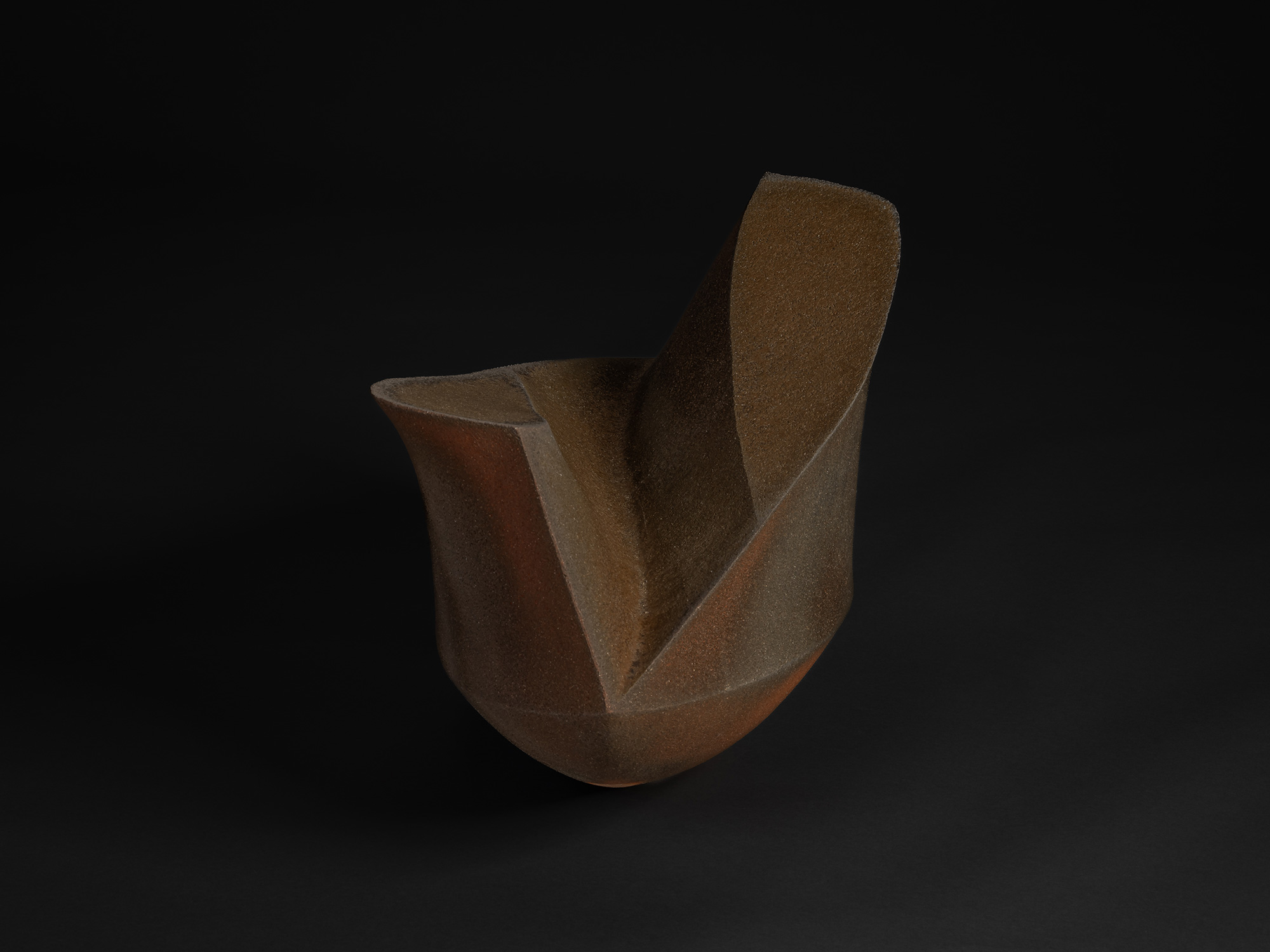 Ceramic sculpture by Shunichi Yabe featuring an elongated, angular vessel form with sharply faceted...