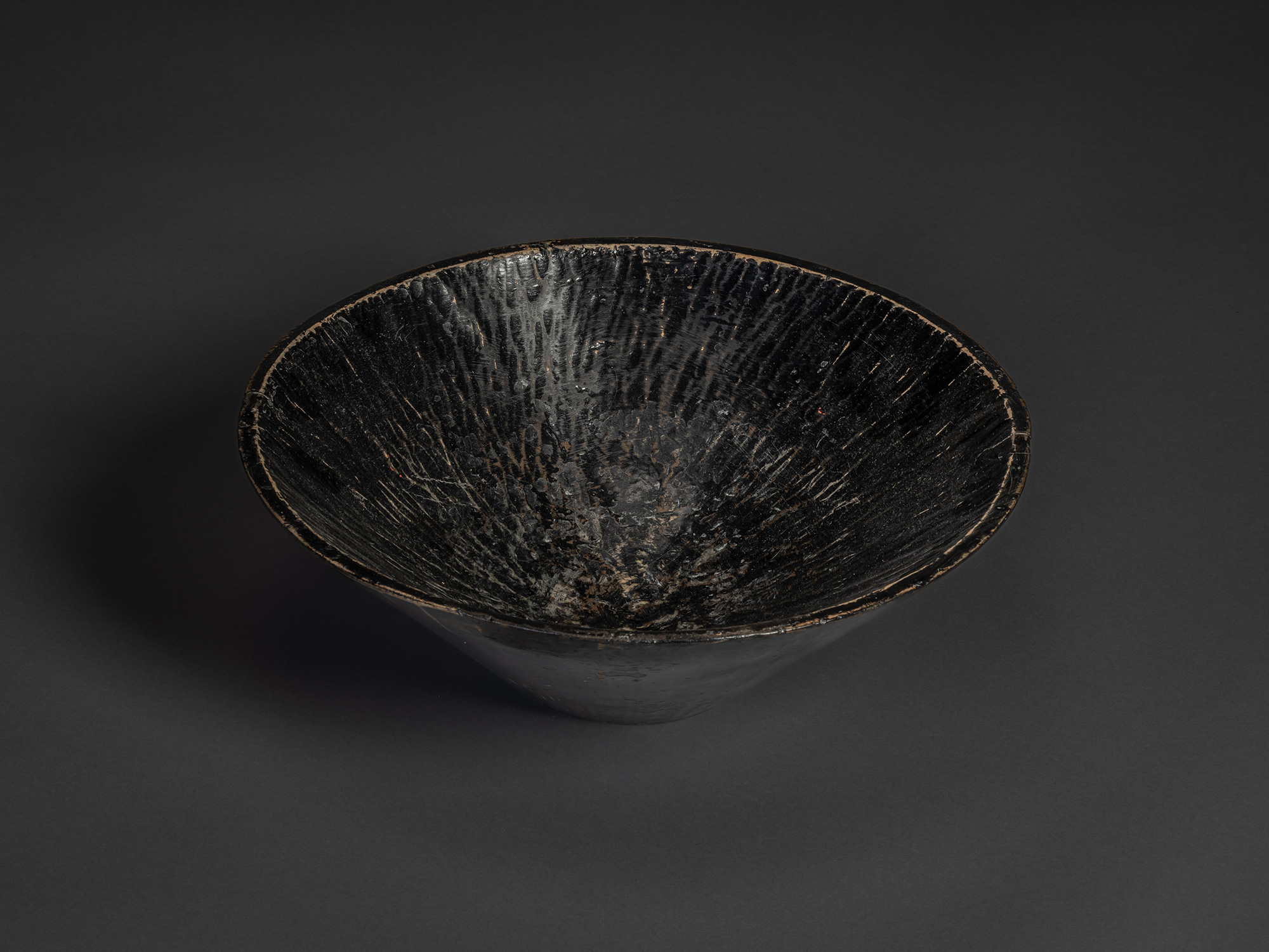Hand-hewn Japanese kneading bowl with deep conical form, carved interior striations, dark patinated...