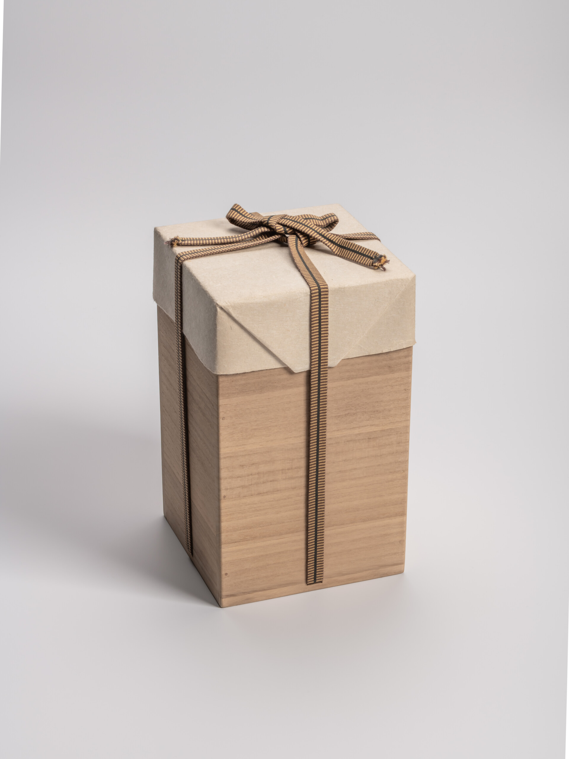 Rectangular wooden tomobako (artist-signed storage box) by ceramic artist, shown with its striped...