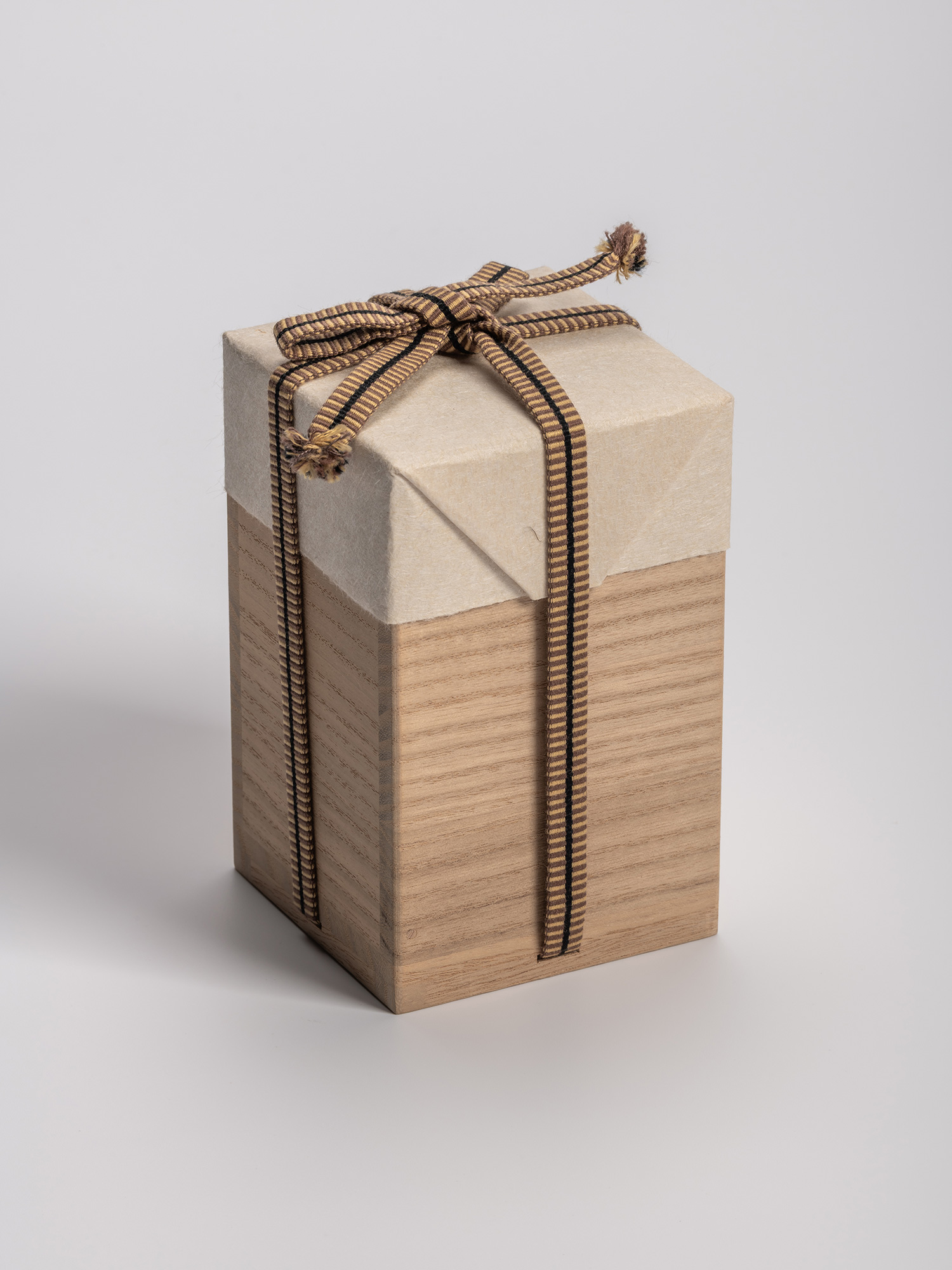 Rectangular wooden tomobako (artist-signed storage box) by ceramic artist, shown with its striped...