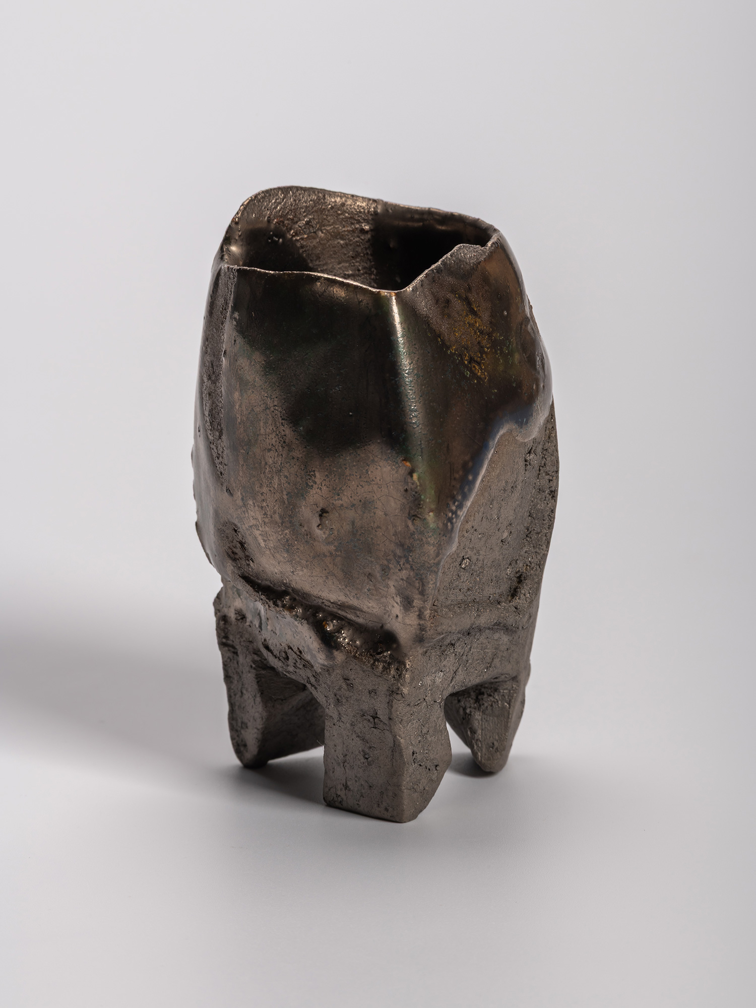 Gray-toned opaque Oribe sake cup with an irregular, sculptural form, subtly distorted rim, and...