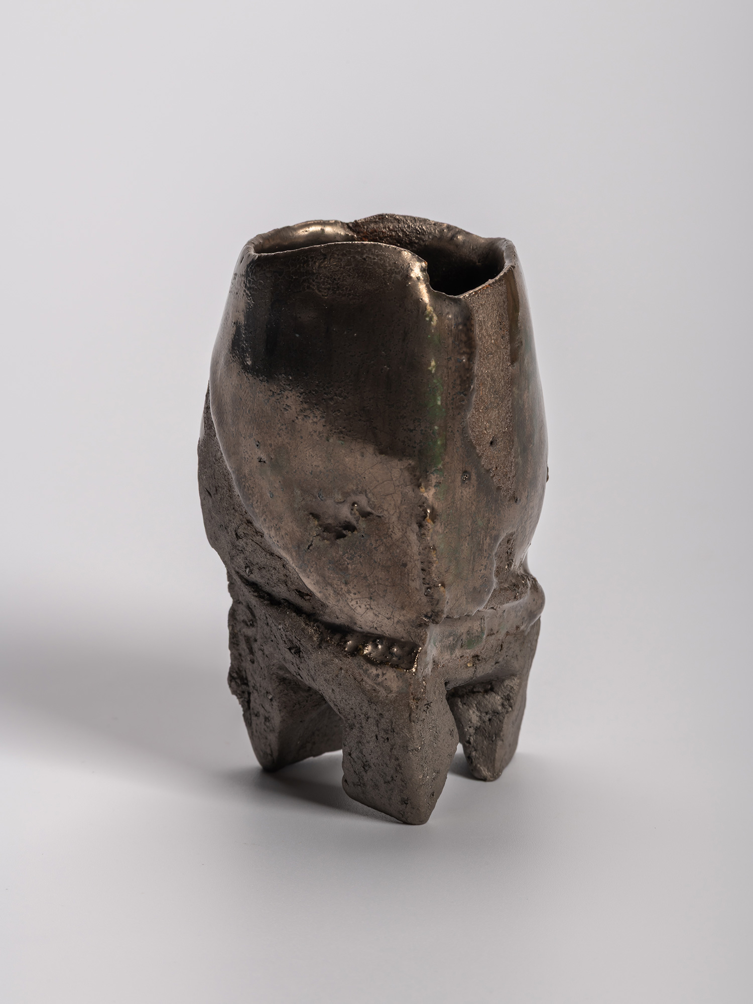 Gray-toned opaque Oribe sake cup with an irregular, sculptural form, subtly distorted rim, and...