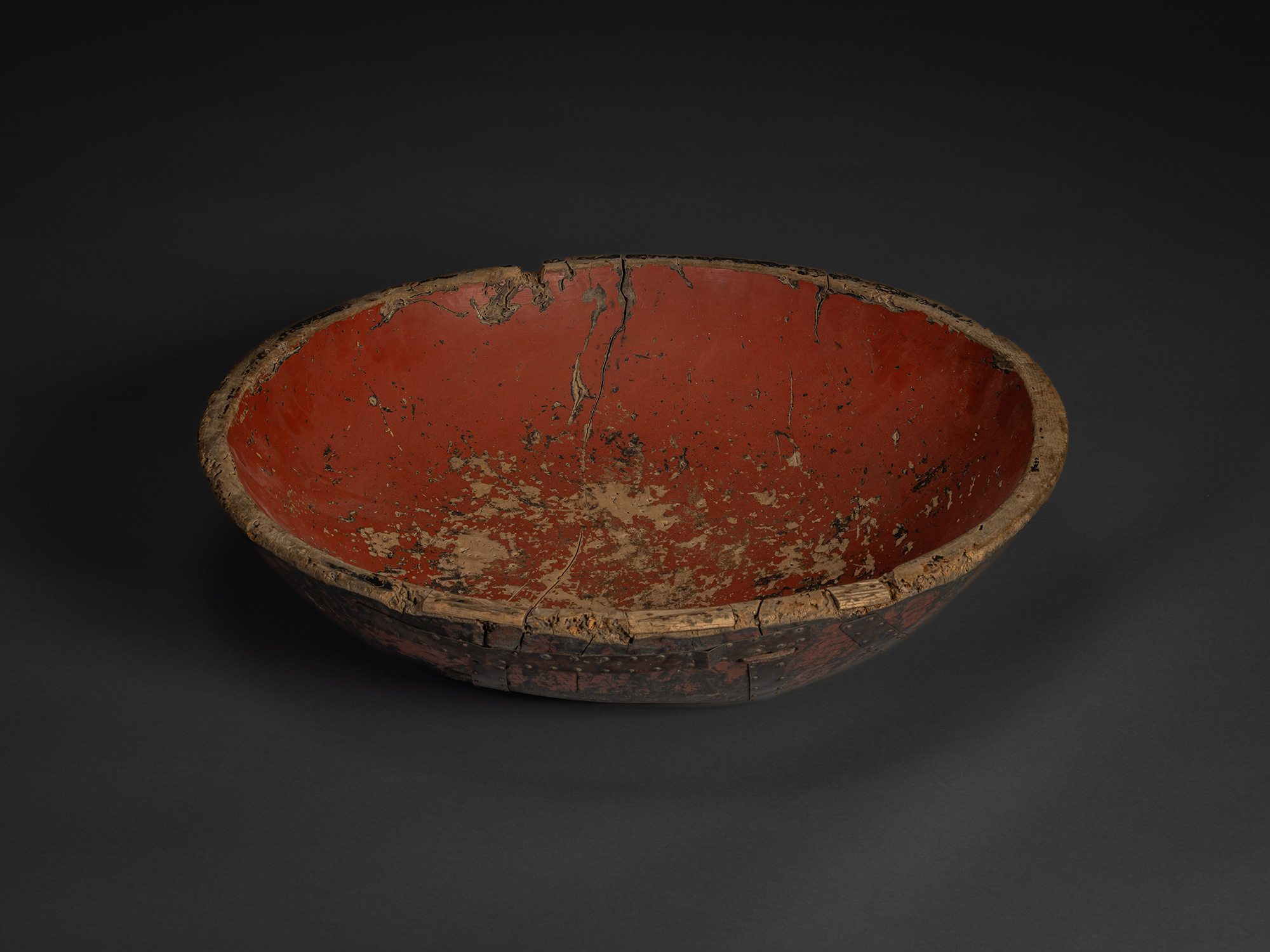 Interior view of early 20th century Japanese kneading bowl, hand-carved wood with worn red lacquer...