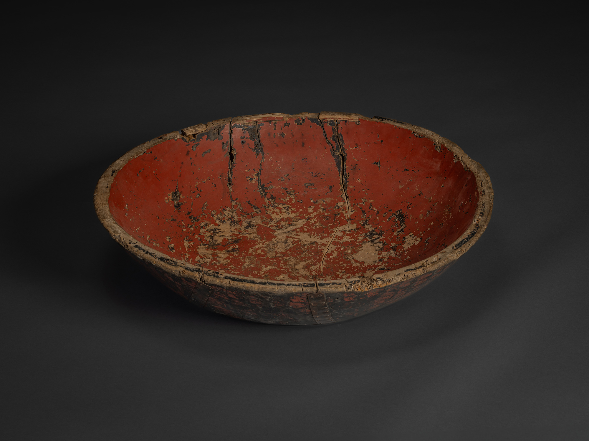 Interior view of early 20th century Japanese kneading bowl, hand-carved wood with worn red lacquer...